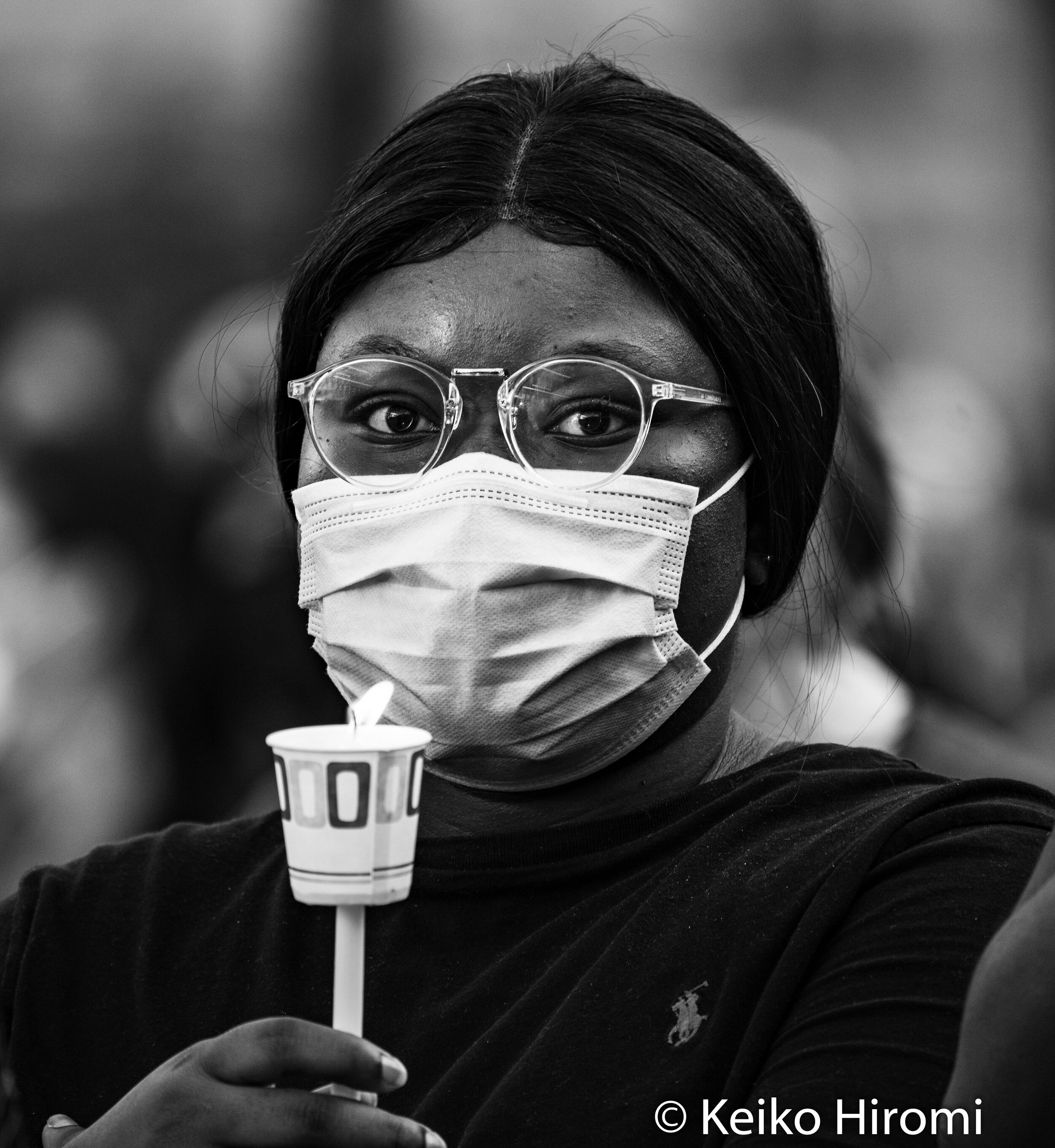  May 30, 2020, Lowell, Massachusetts, USA: A protester holds a candle during a rally in response to deaths of George Floyd and against police brutality and racism at JFK plaza in Lowell. 