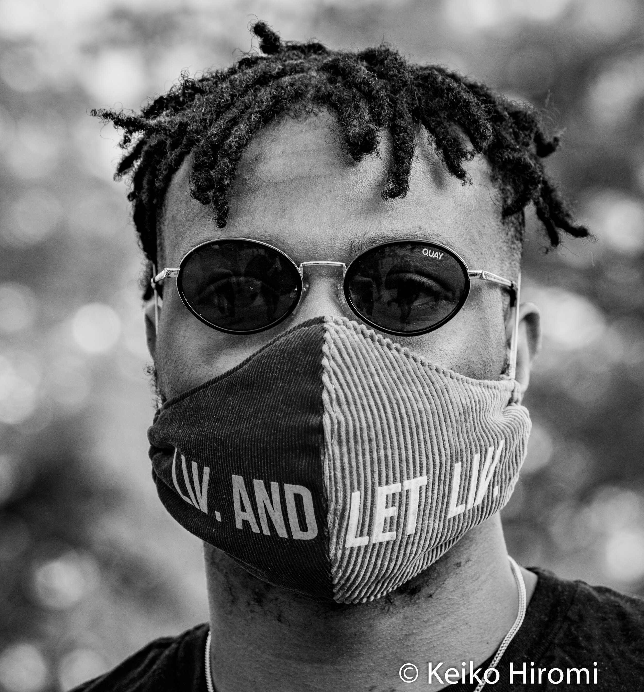  May 30, 2020, Lowell, Massachusetts, USA: A protester  wears a face mask "liv and let liv" during a rally in response to deaths of George Floyd and against police brutality and racism at JFK plaza in Lowell. 