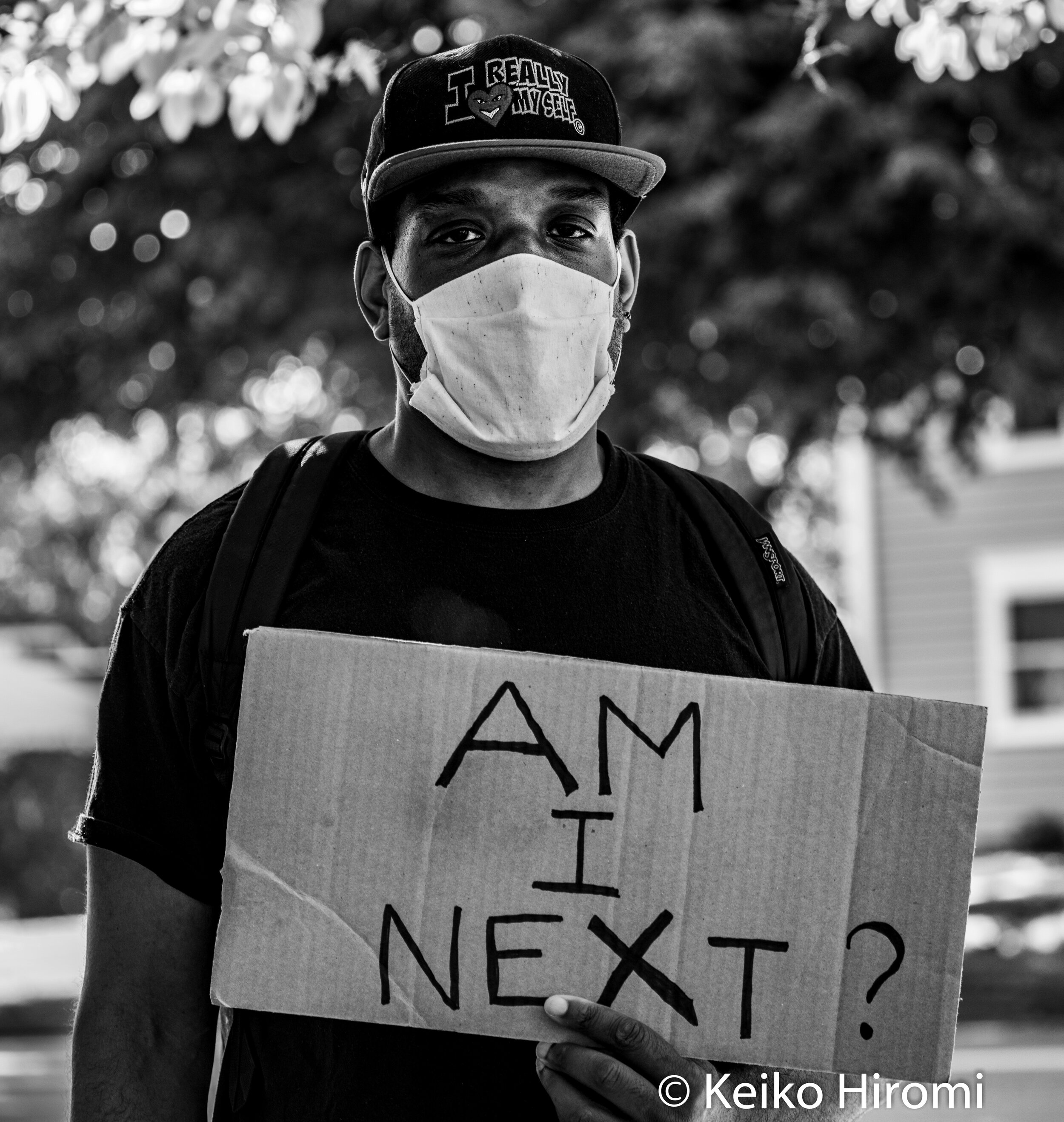 June 8, 2020, Lynnfield, Massachusetts, USA: A protester holds a sign "Am I next?" during a rally in response to deaths of George Floyd and against police brutality and racism in Lynnfield. 