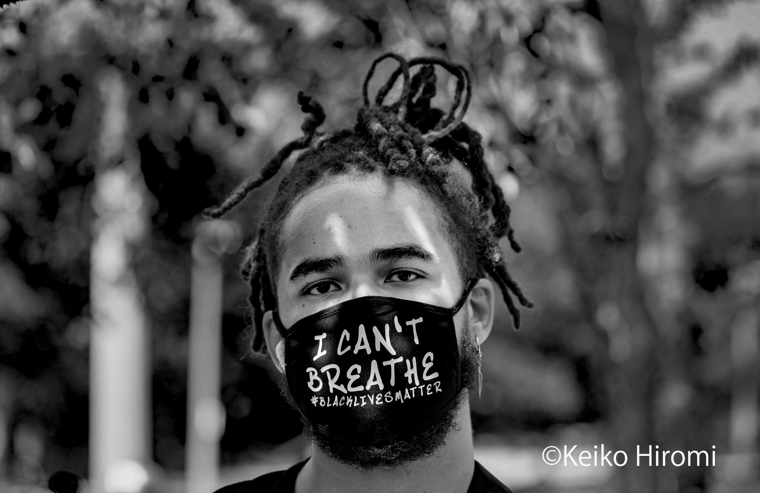  June 22, 2020, Boston, Massachusetts, USA: A protester wears a face mask " I can't breathe" during a Black Lives Matter rally in a response to a death of Rayshard Brooks and against police brutality and racism in Boston.  