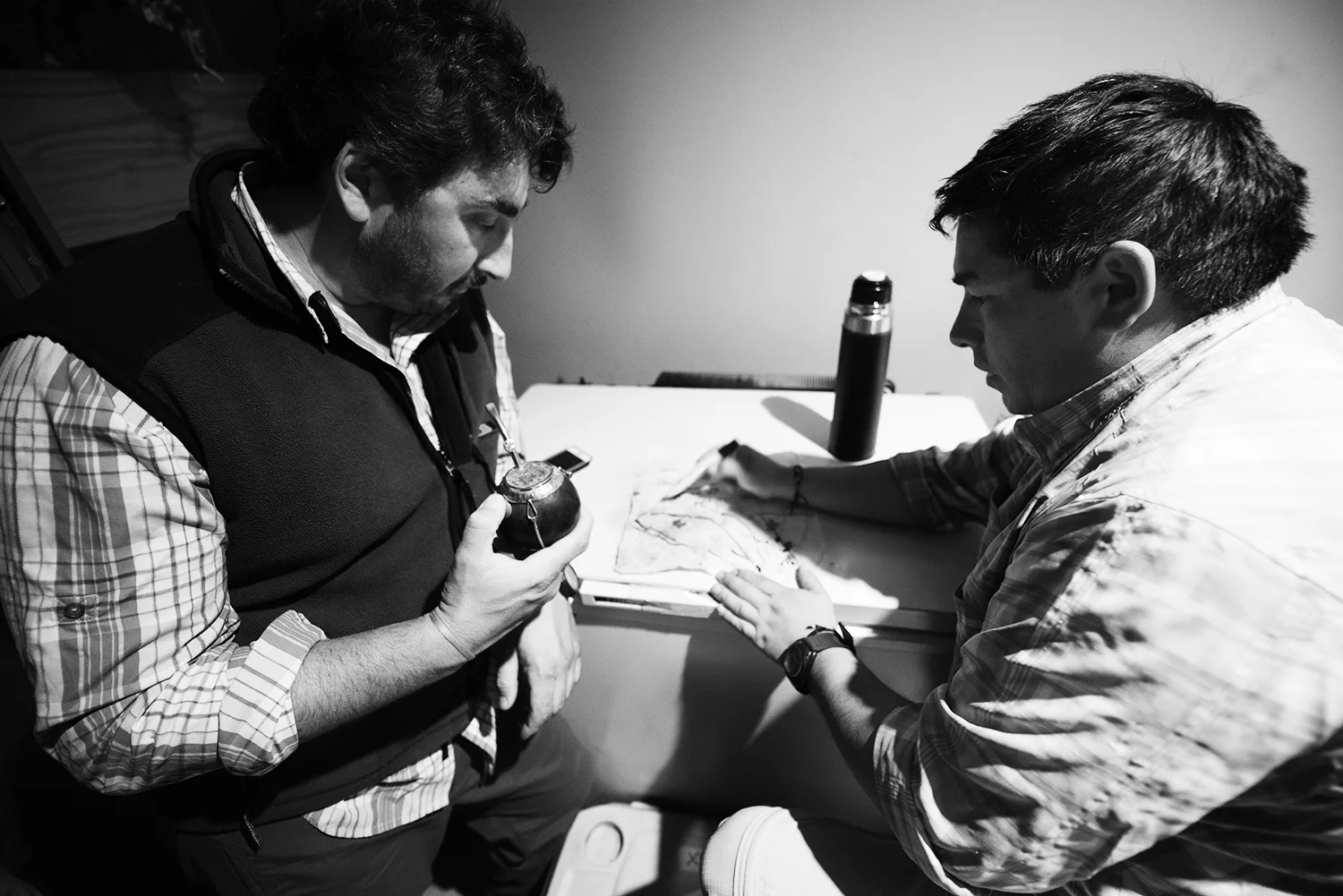 Nano and Fabian have matte and discuss the Limay River channels with a hand drawn map