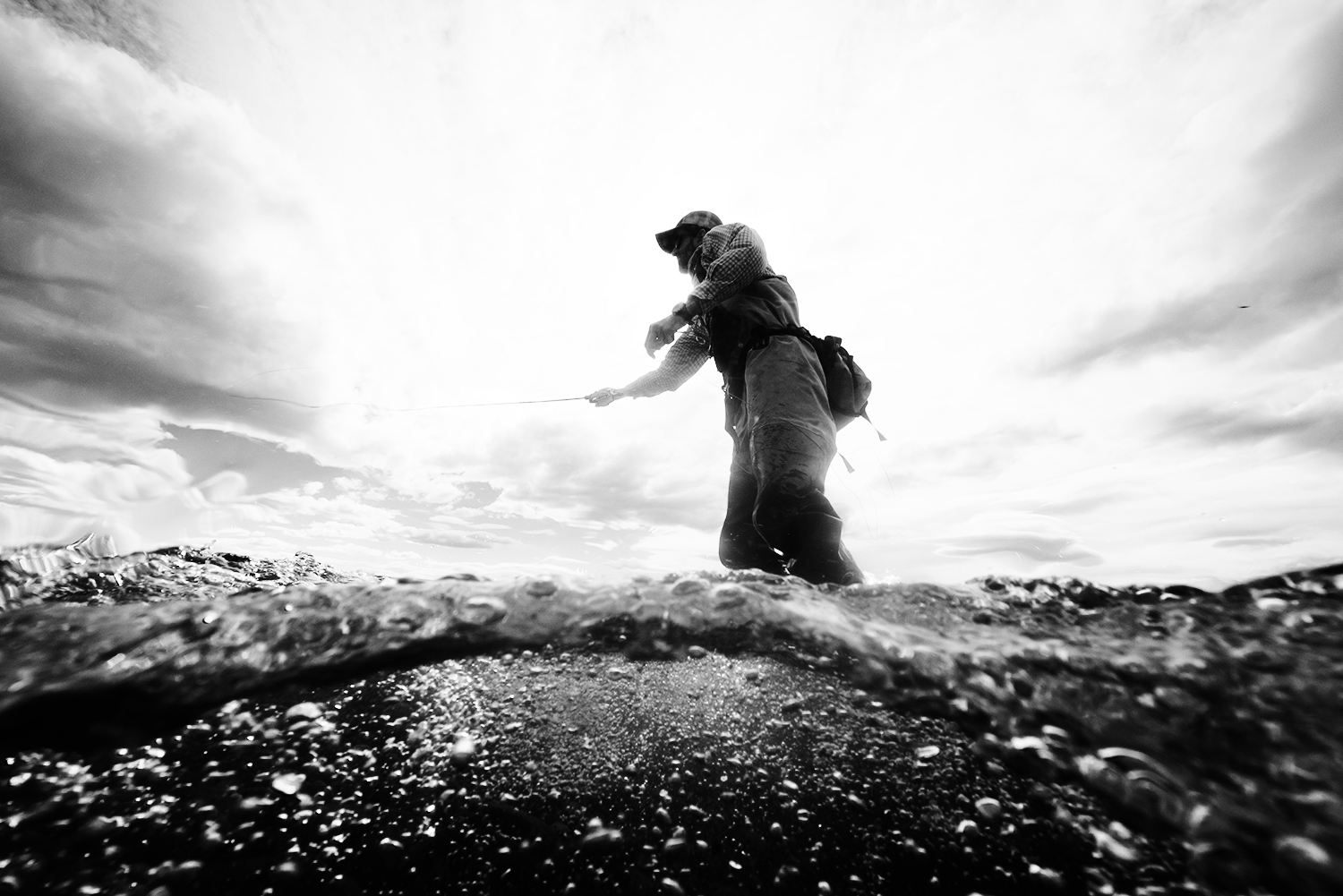 Black and white split shot of a fly fisherman in Argentina