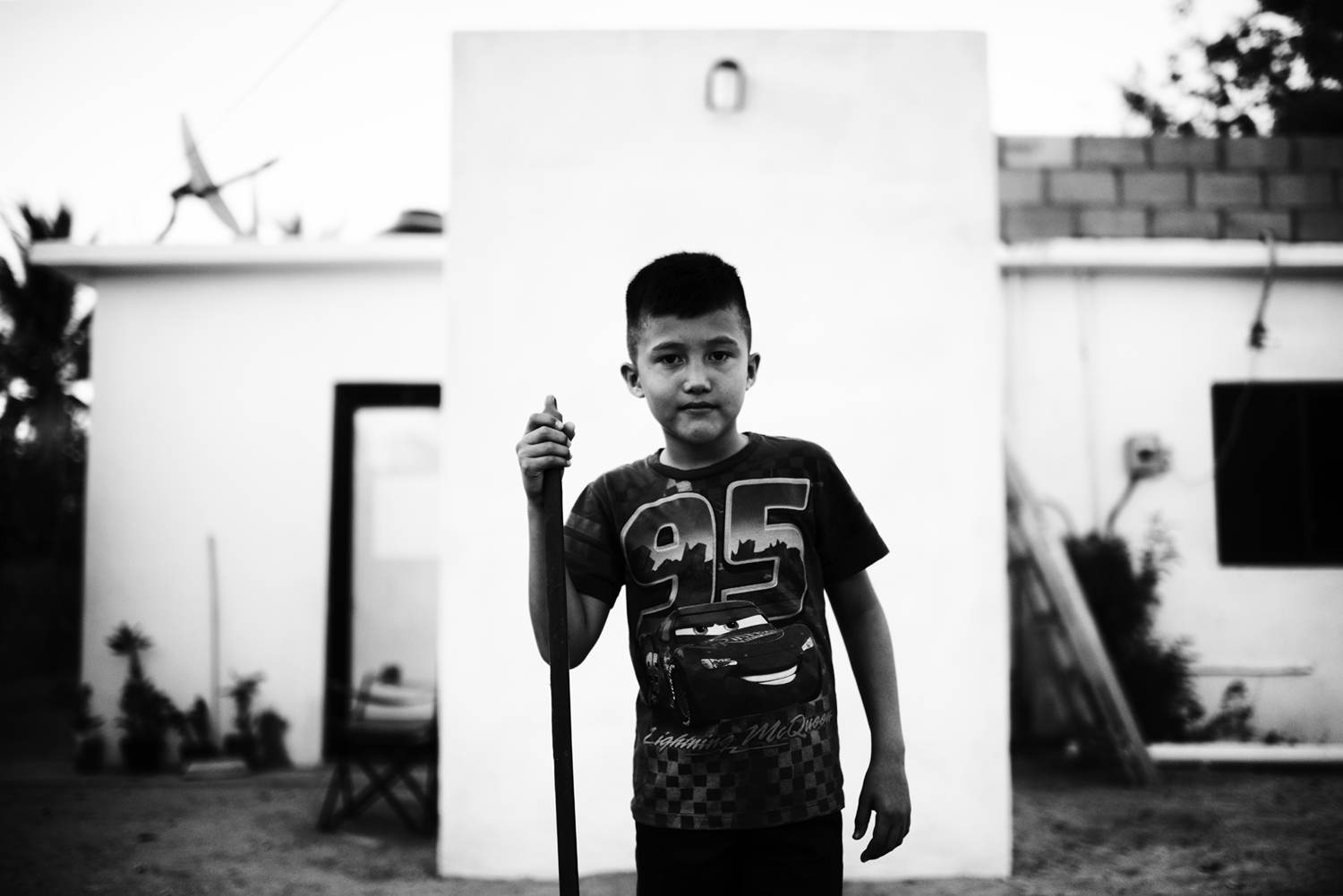 Young Boy In Front of House