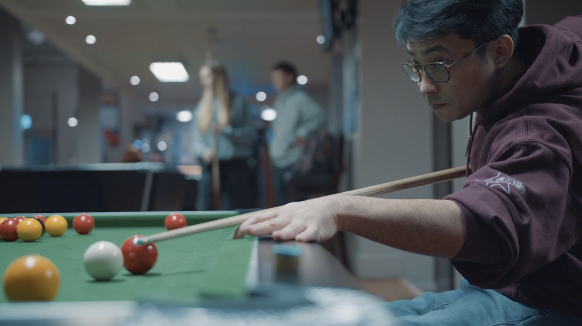 A guy plays pool
