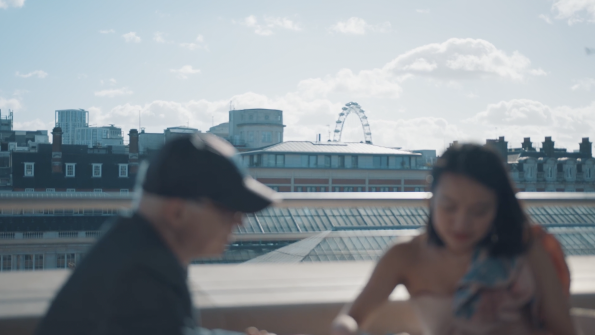 An artist looks at her sketches on a rooftop in London