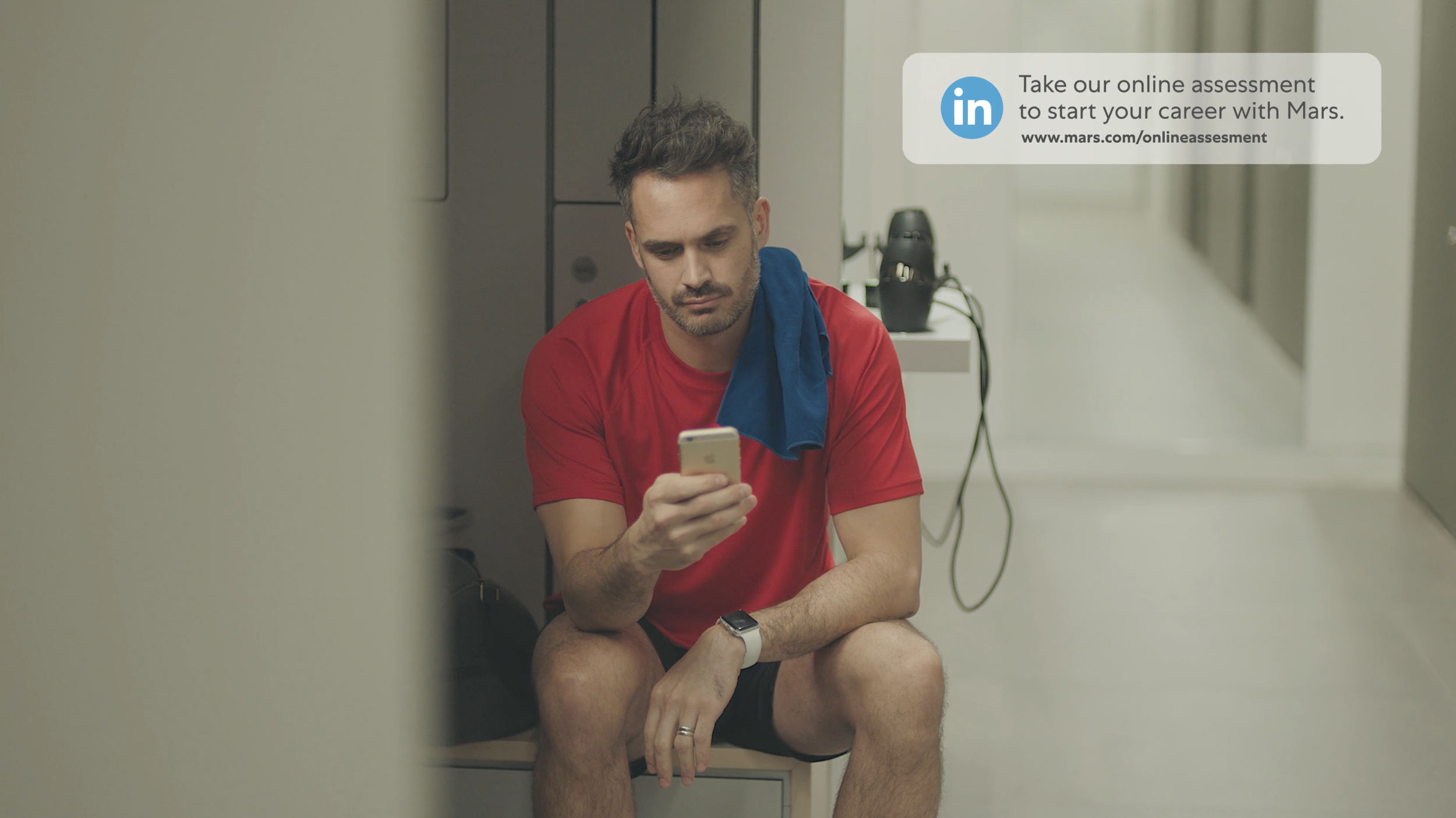 A guy gets a notification in a gym