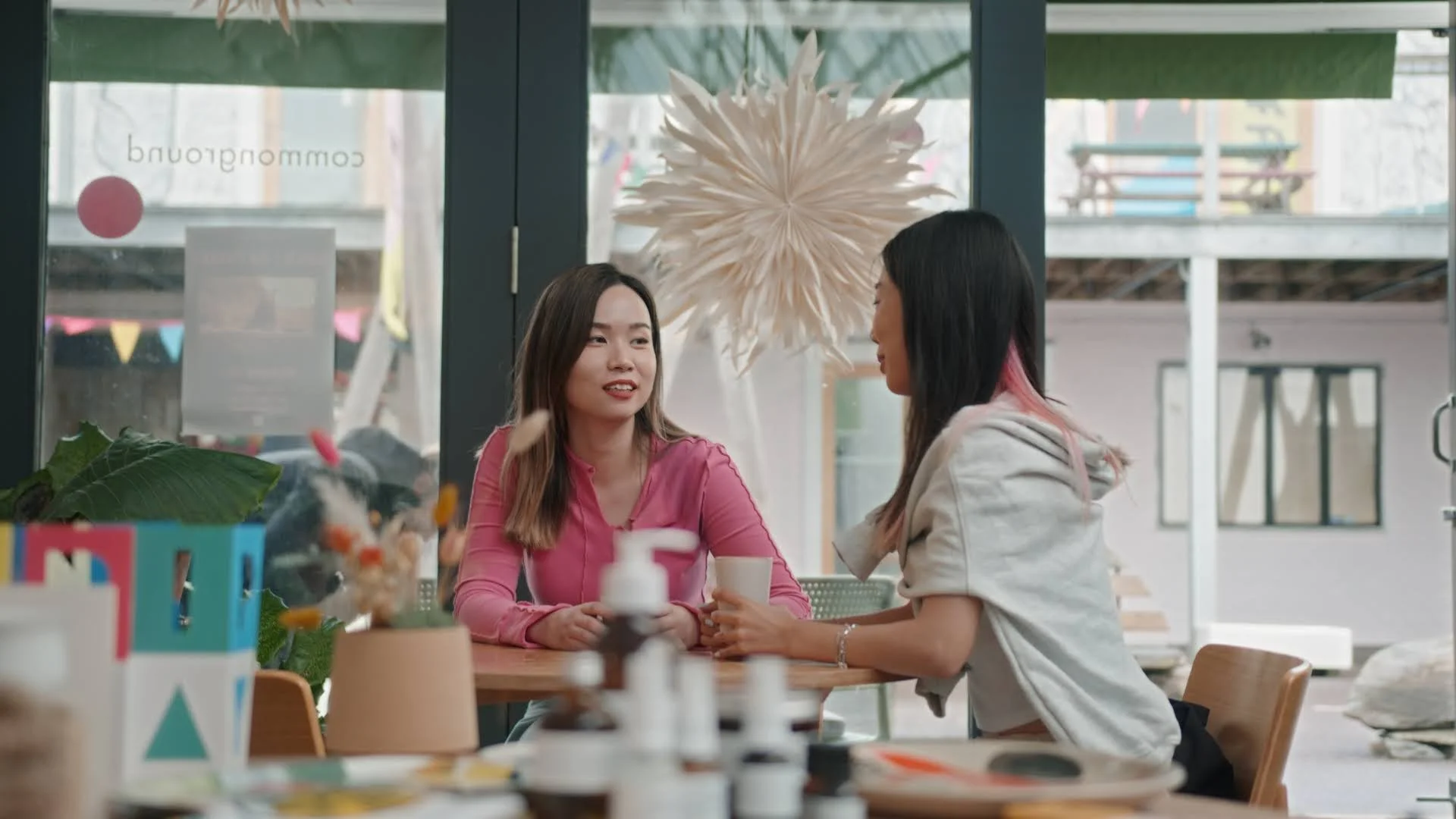 Two girls drink coffee