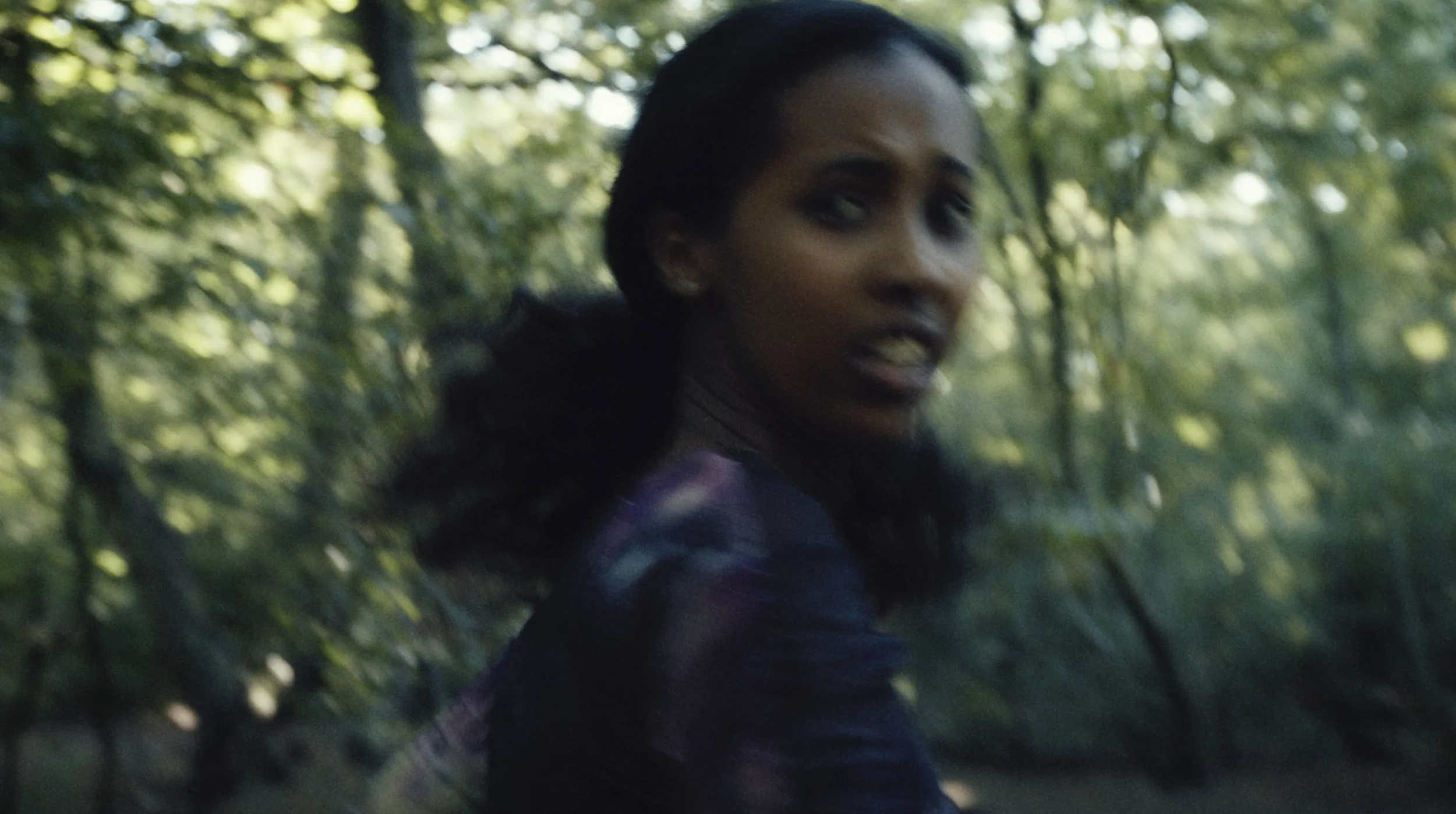 A girl runs in a forest