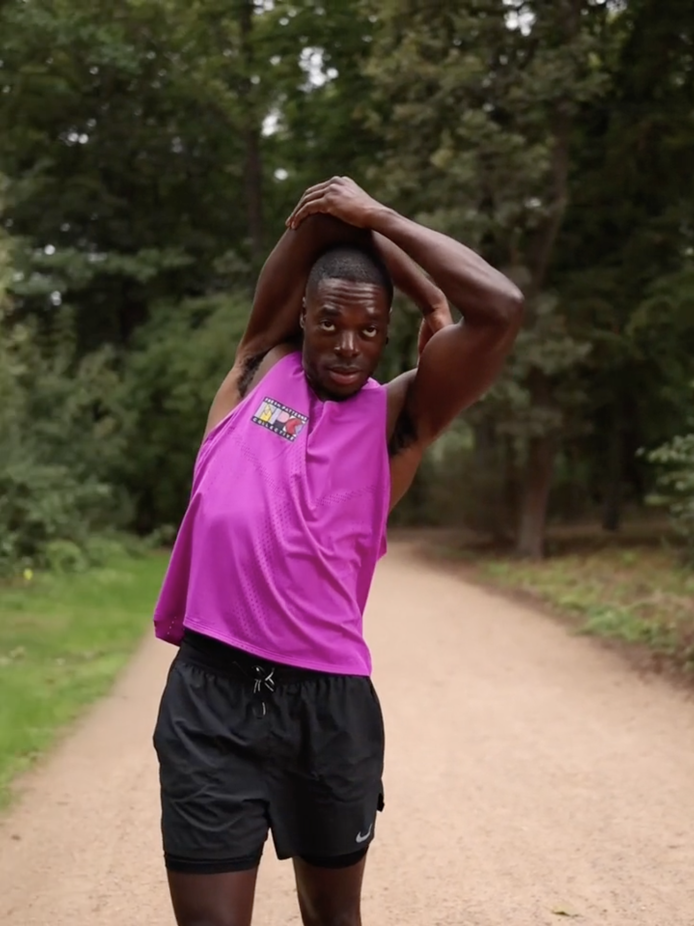 A Nike runner pauses in a park to stretch edited by Jess Dowse.png
