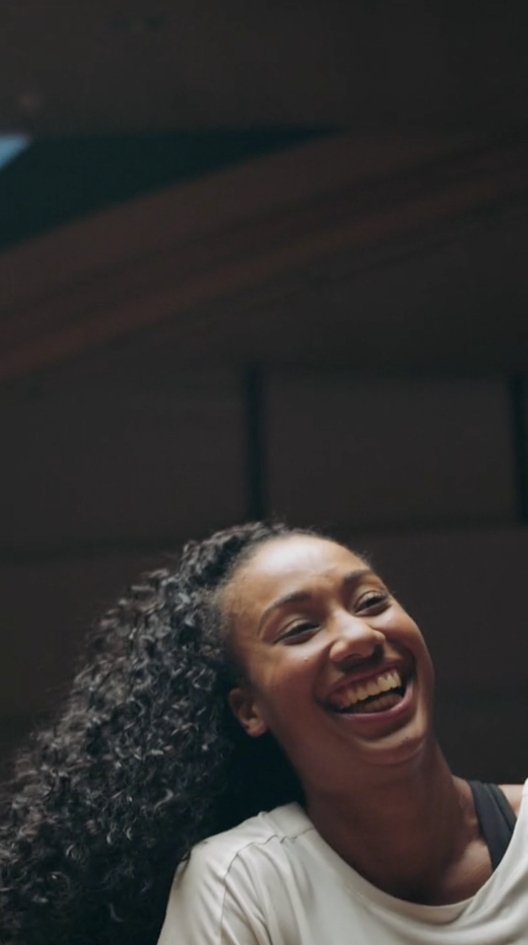 A woman laughs in a warehouse for Puma edited by Jess Dowse.png