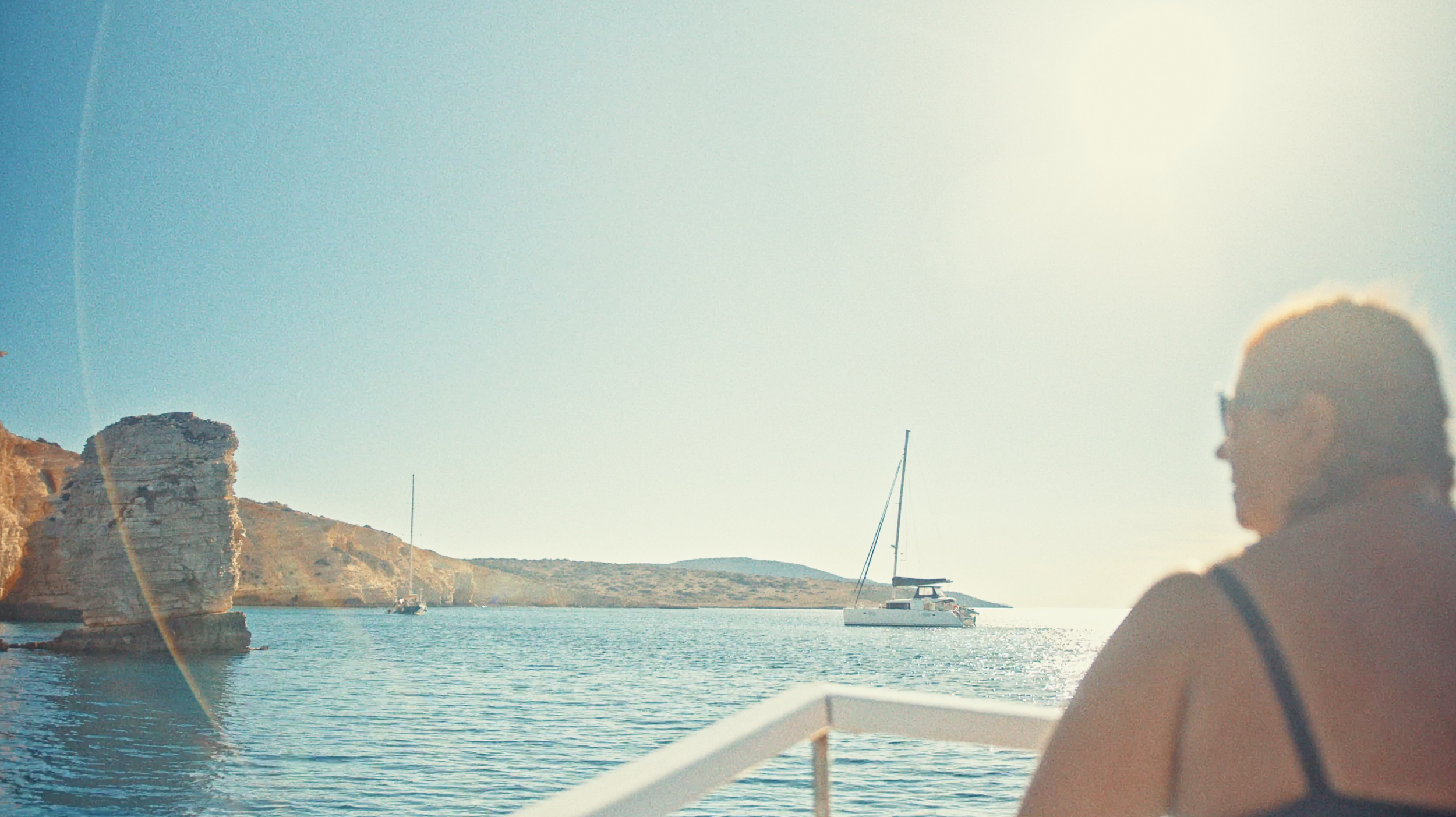 Wild-Swimmer-on-a-boat-in-Greece-in-a-documentary-for-Swimtrek-by-writer-director-editor-Jess-Dowse.png