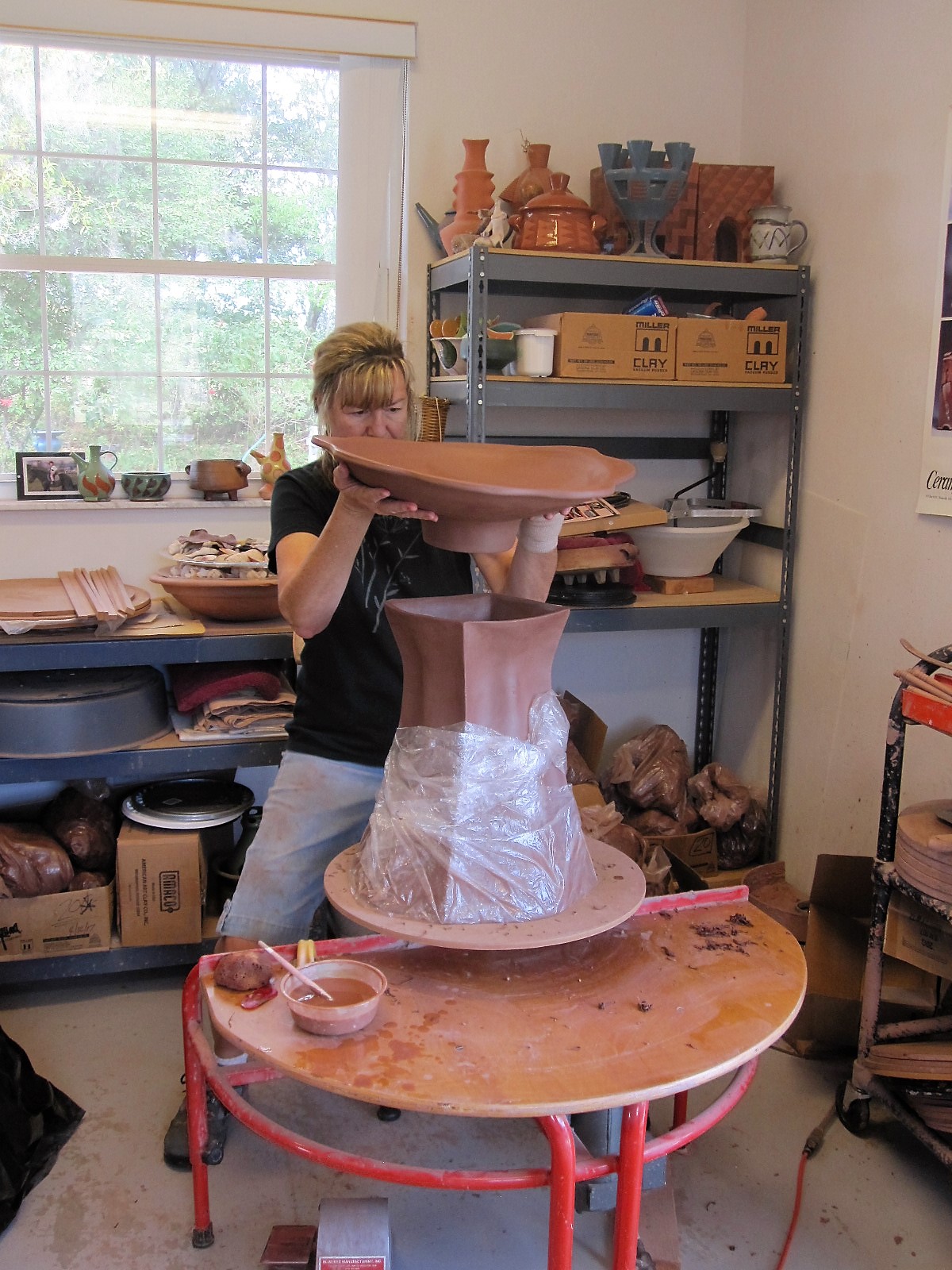 Michele Ginouves adding bowl to birdbath.JPG