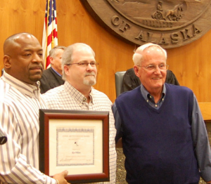 Ron Wilson holding his James Wanamaker Award for Outstanding Graduate with Michael Mooradian and Judge Jim Wanamaker (at right).