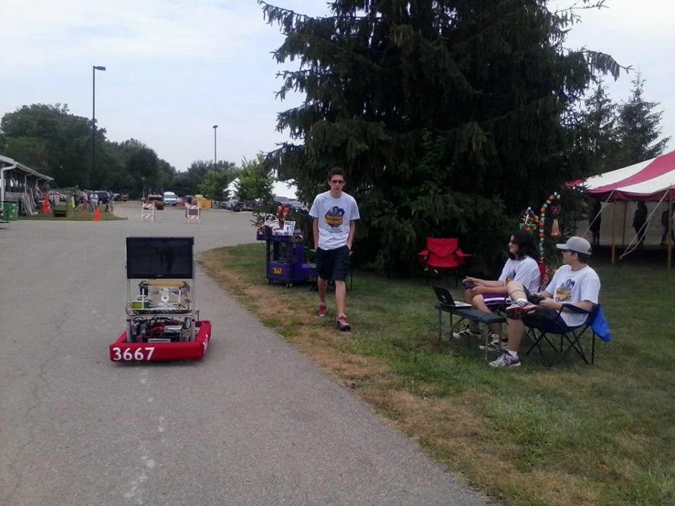 Mark,Garrett and Nathan work the bot at the fair.