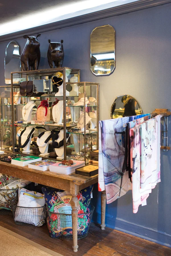 Display cases, jewelry scarves, and pillows at Flat 128 