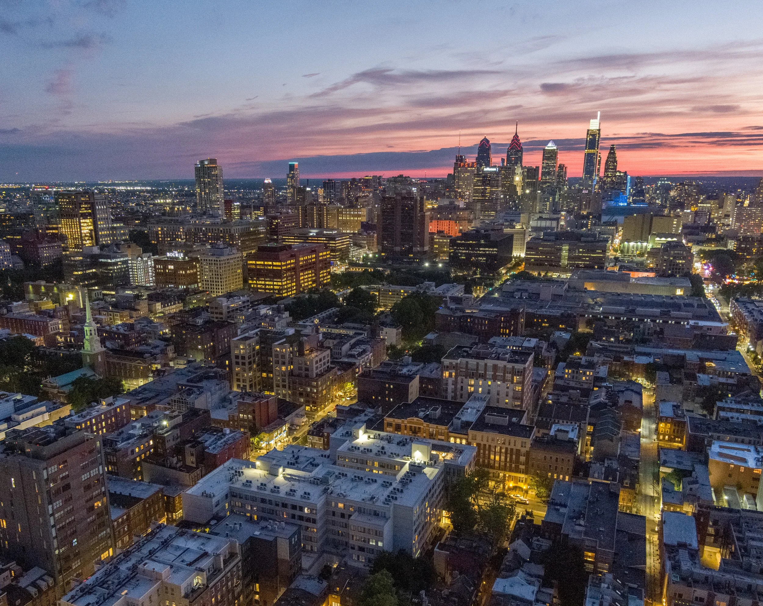   The lingering sunset highlights the Philadelphia skyline behind apartments in Old City.  