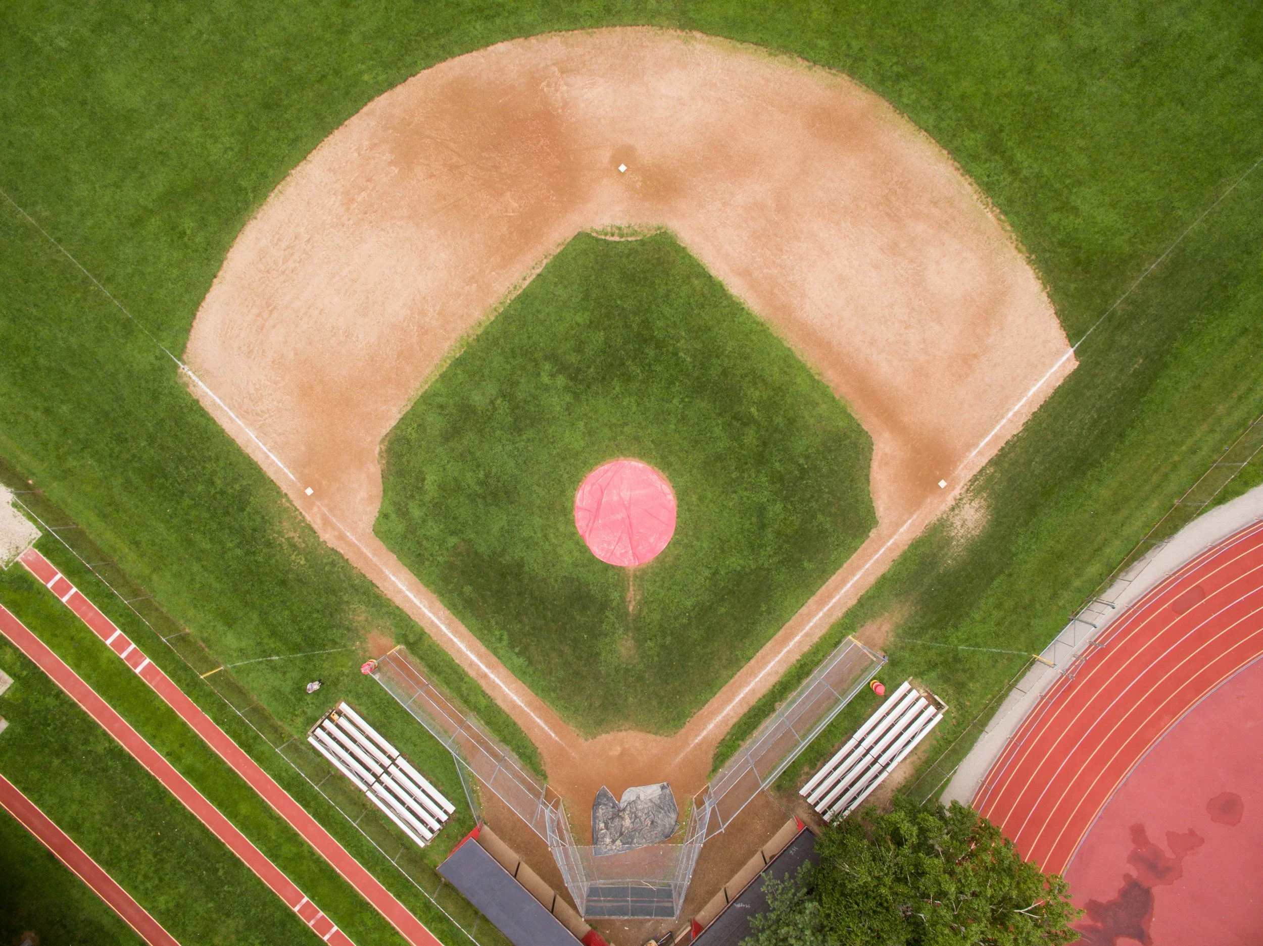   The bright red protective cover on the pitcher’s mound coincidentally almost matches the track next door.  