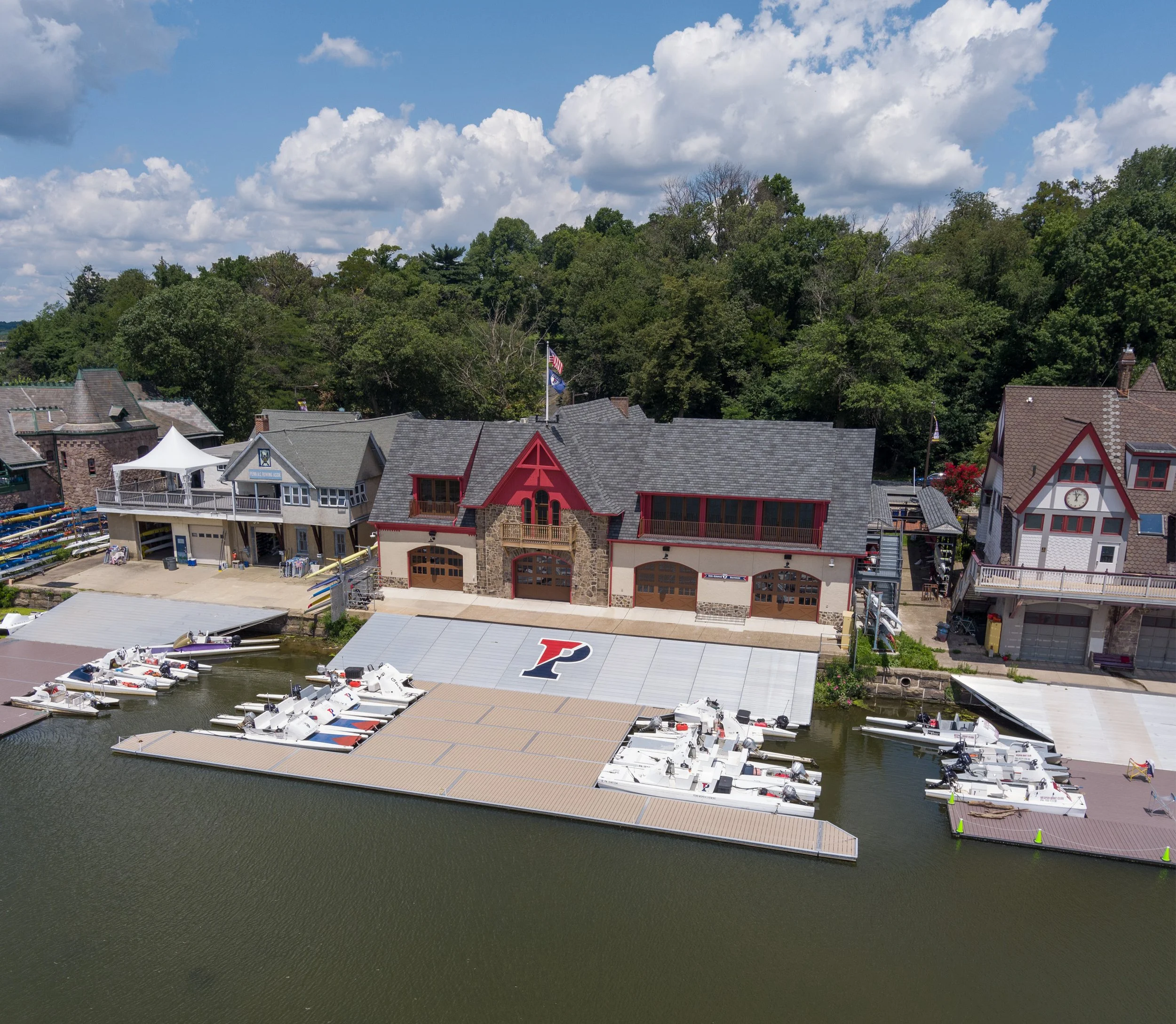   Calm waters and a vibrant blue sky set the scene at the University of Pennsylvania’s Burk-Bergman Boathouse.  