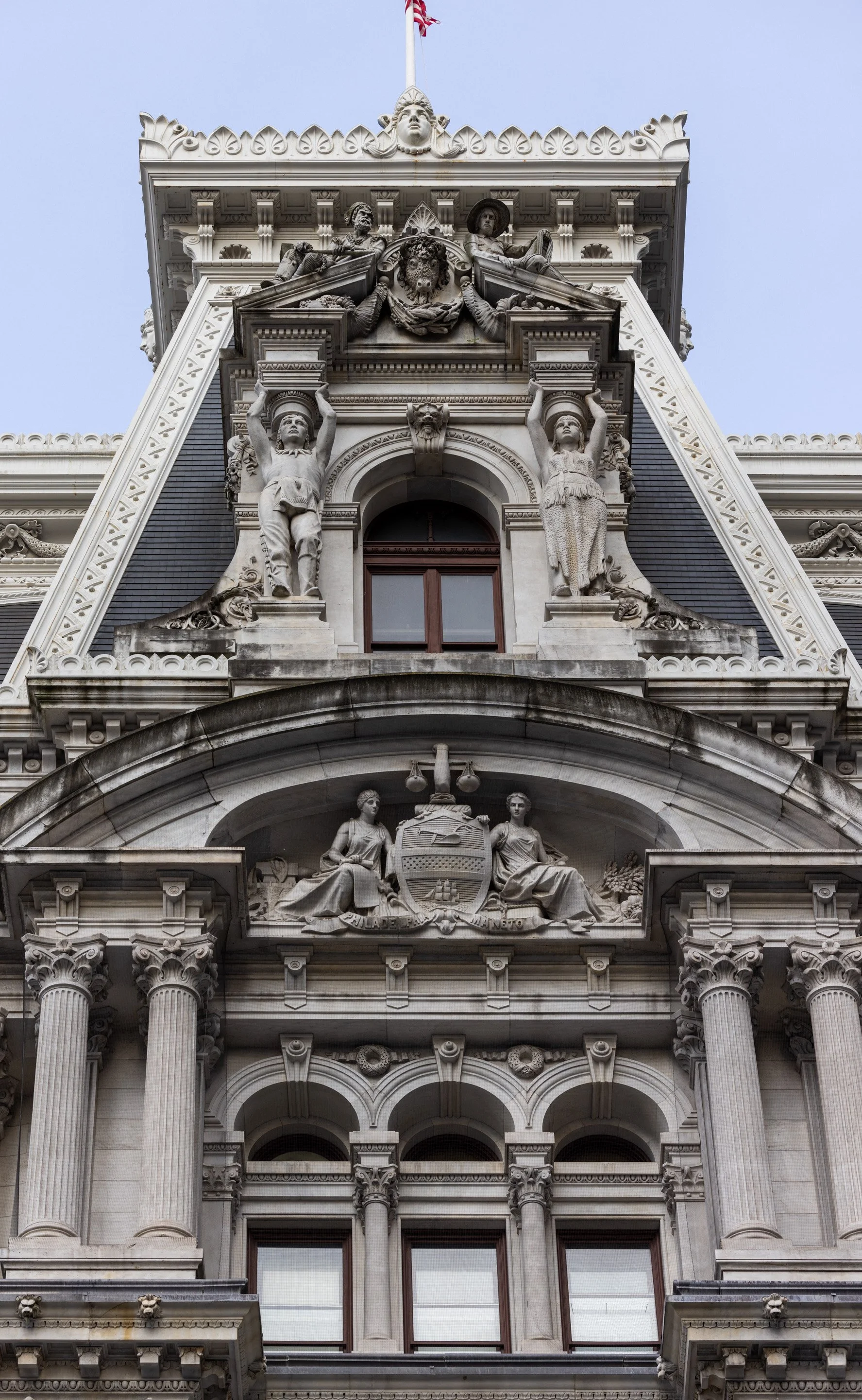   From top to bottom: the head of a bison, two figures representing Native Americans, and an interpretation of the Philadelphia city seal.  