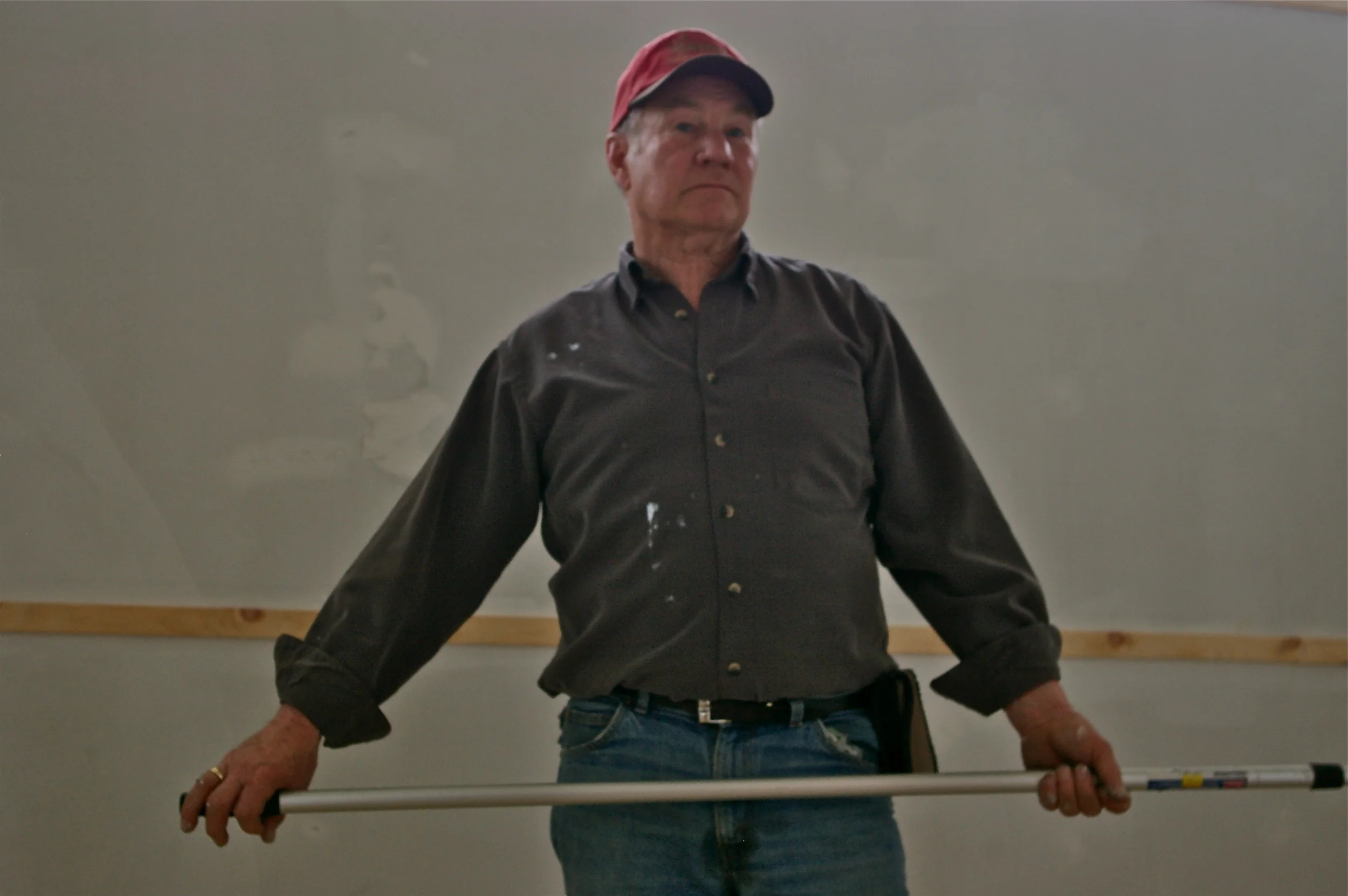 Harry Danford paints the Hastings County Building in Heritage Village.