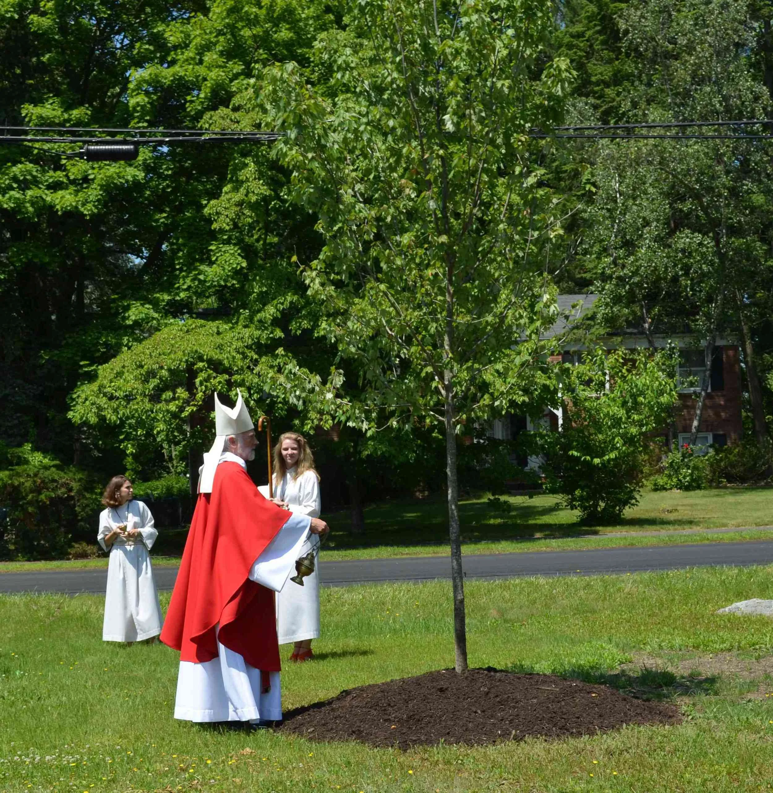 Bishop Smith dedicates one of the maple trees