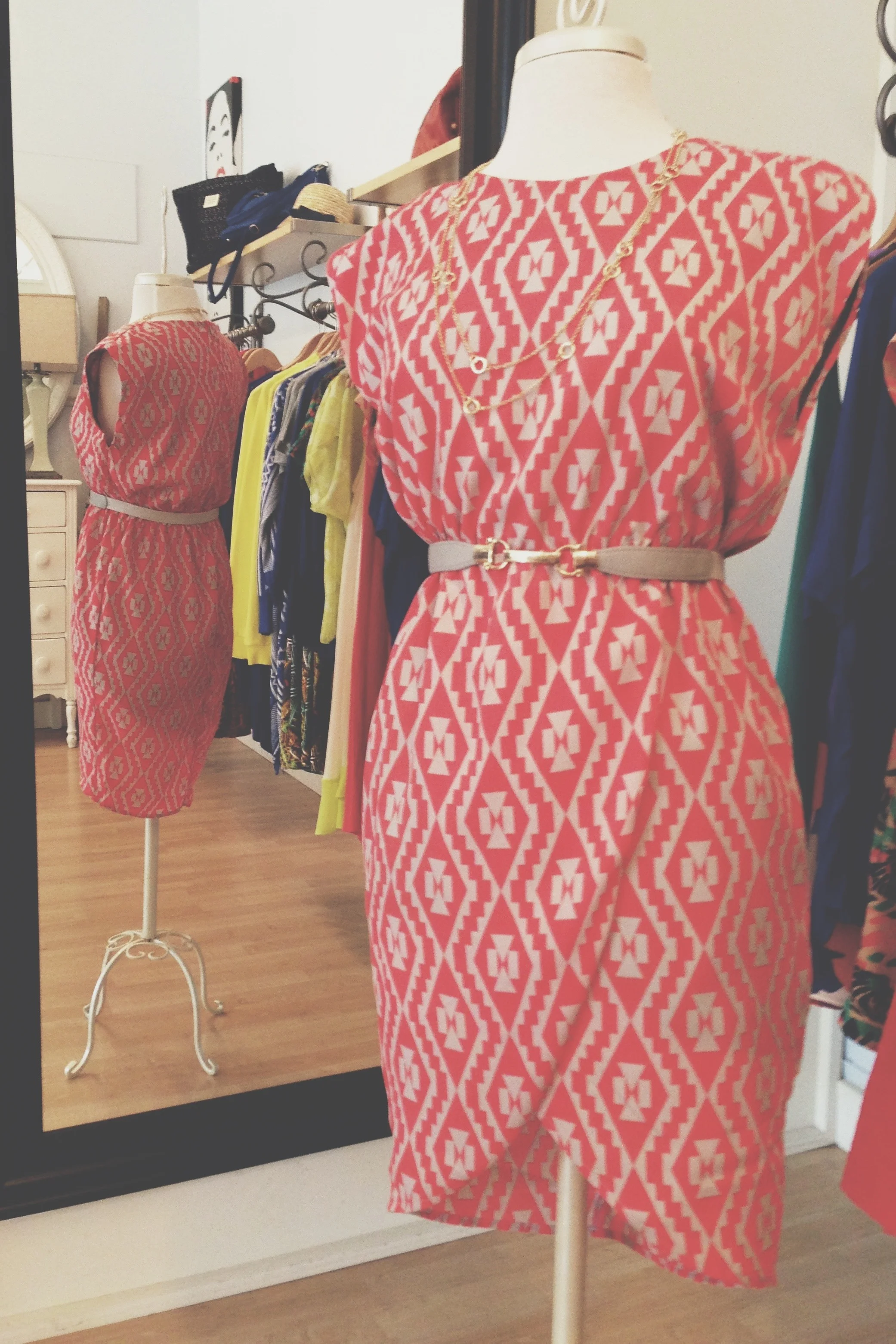 Red + Tan print dress belted with a necklace.