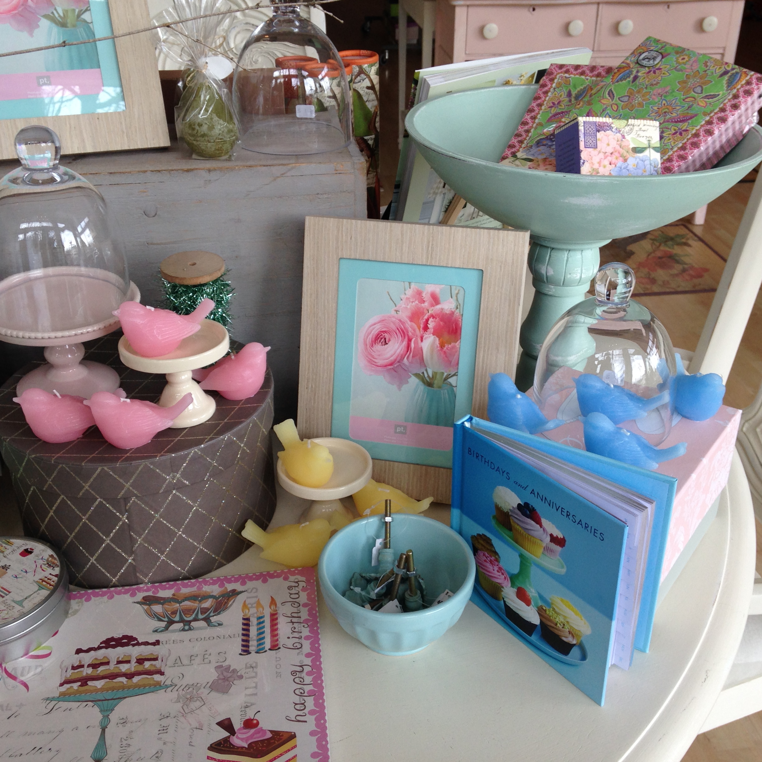 pring colored bird candles in pink, yellow, blue and green