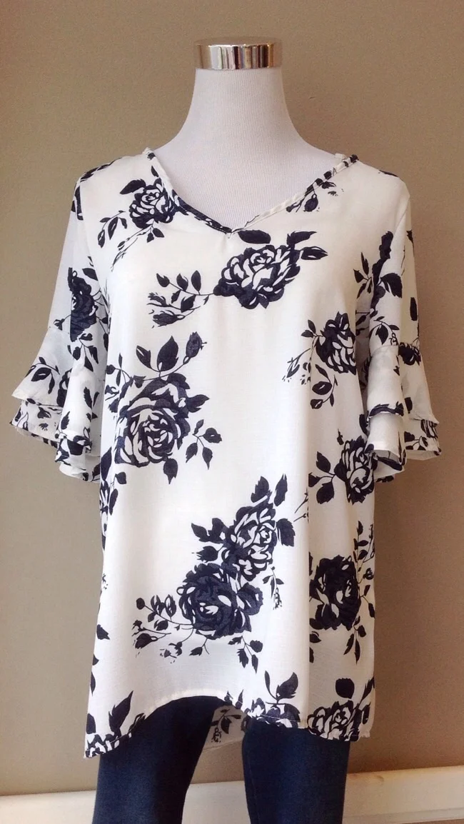 Floral v-neck blouse with ruffle sleeve and high-low hem in white/navy, $35