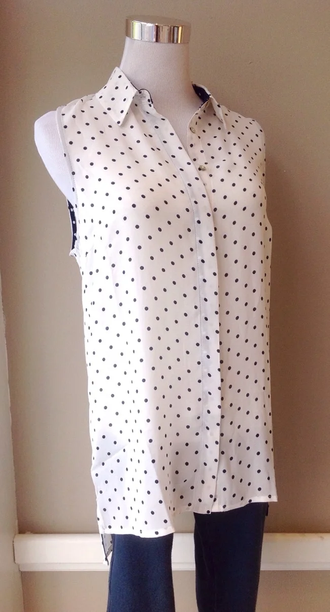 Sleeveless white and navy polka dot button-down with high-low hem, $32