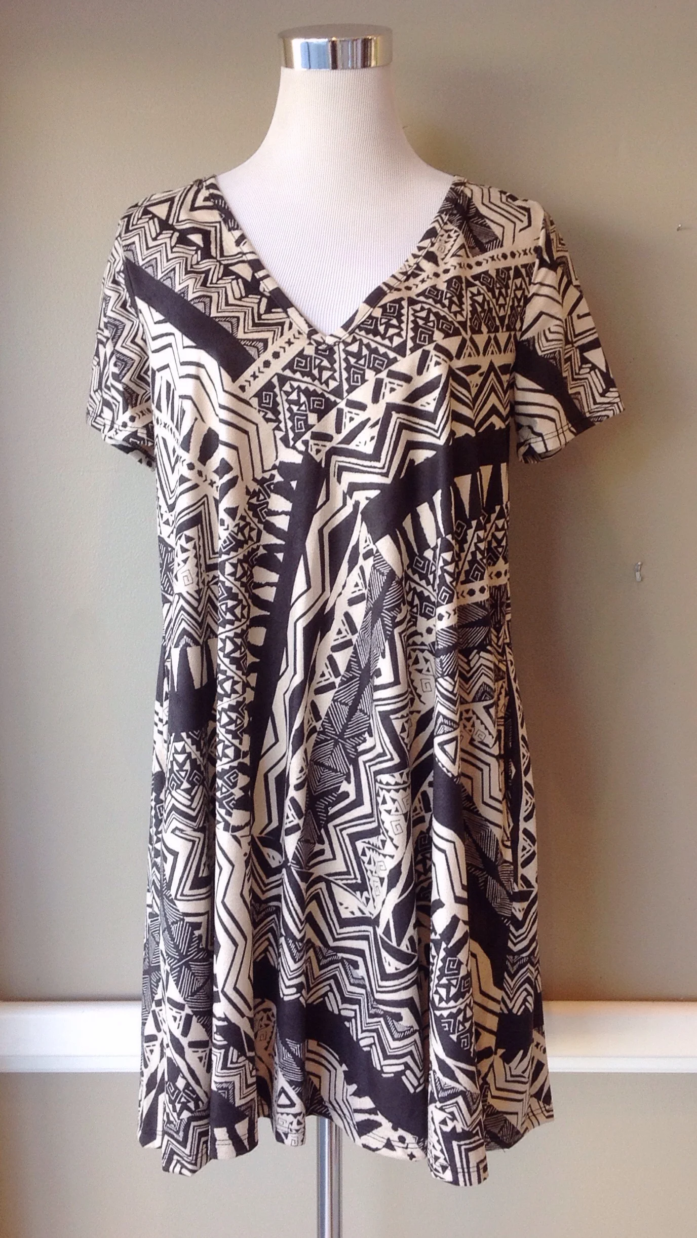 Woven swing dress with side pockets in taupe/brown, $38