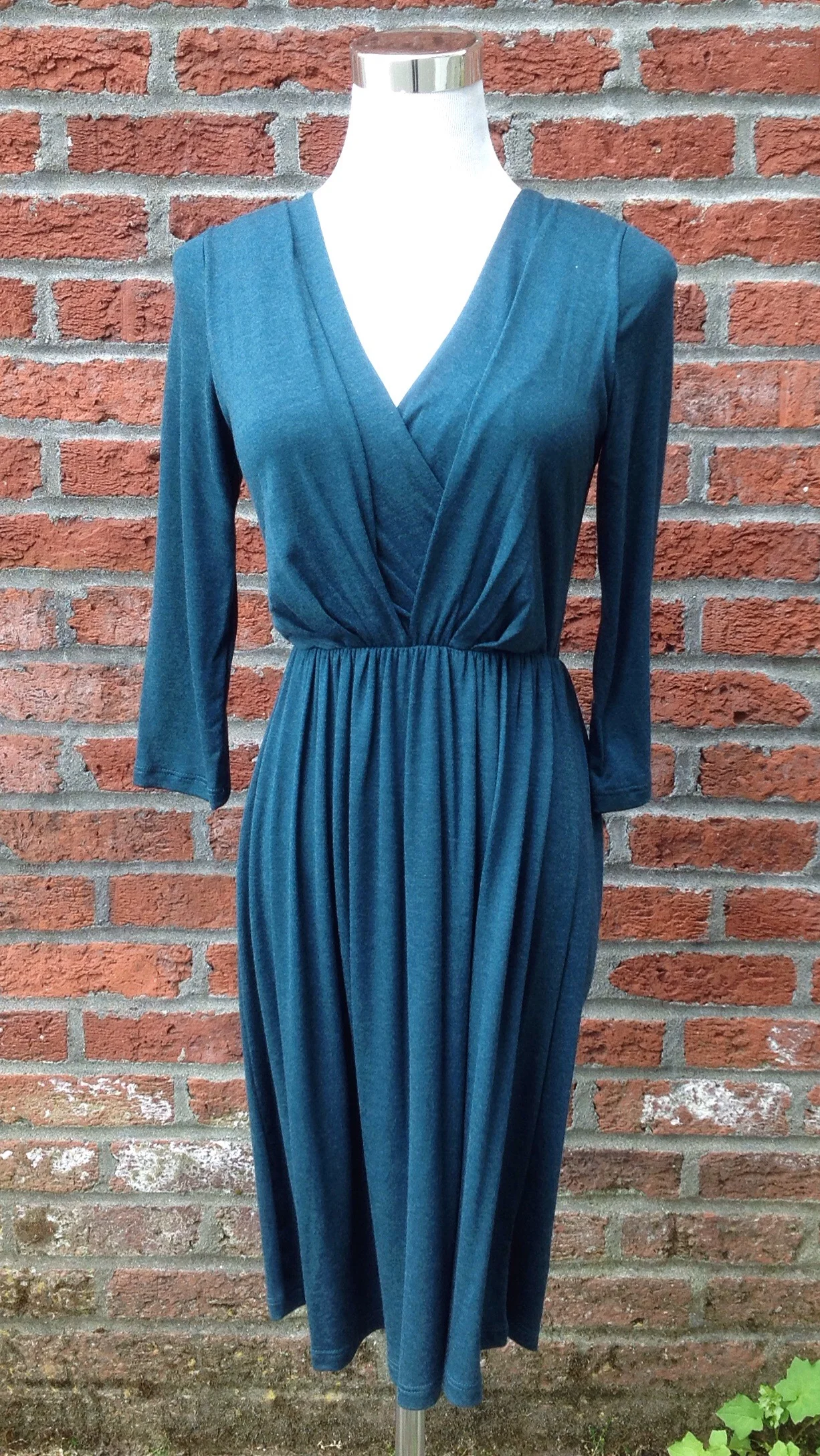 Teal knit dress with front pleats and gathered waist