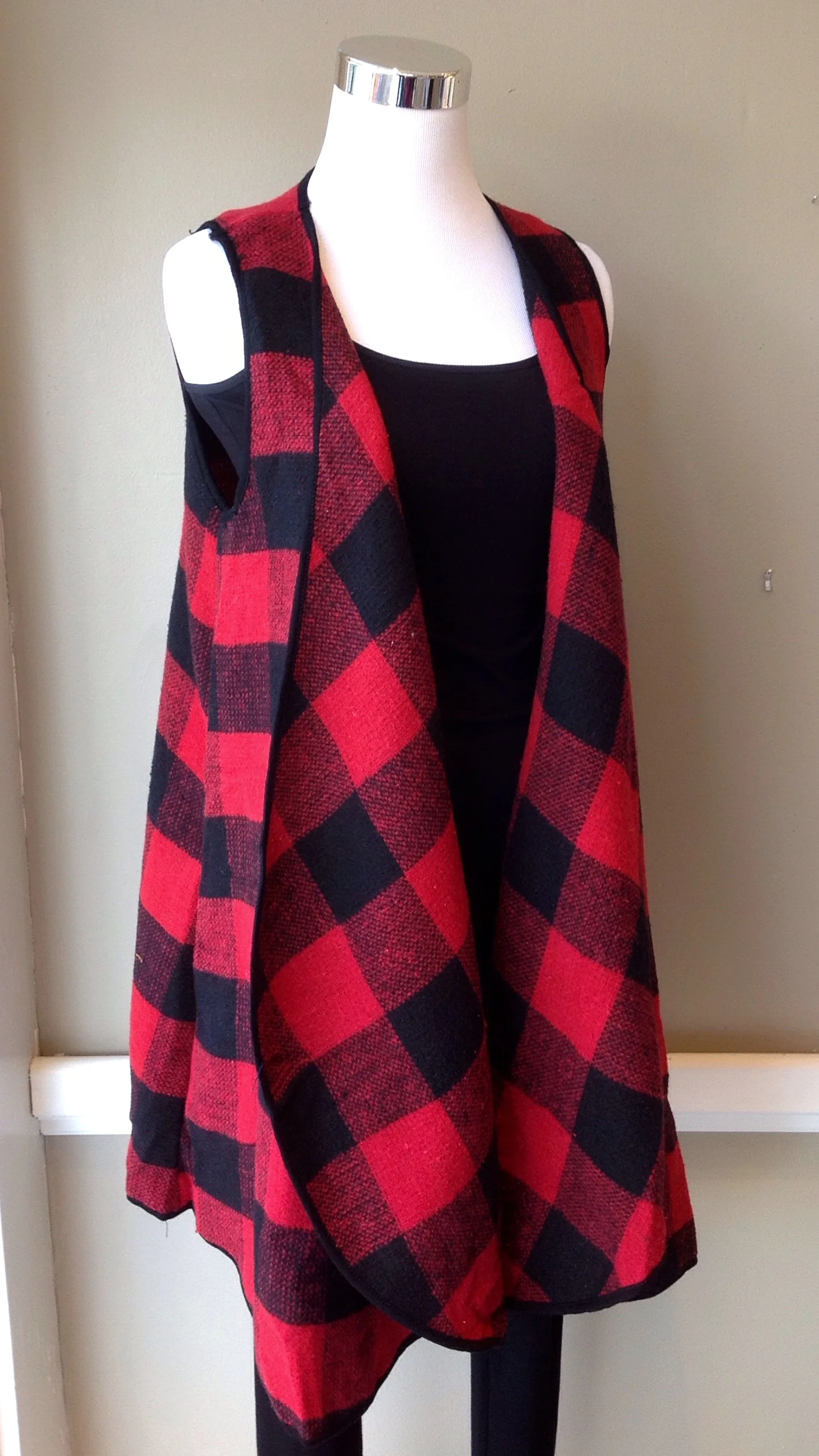Red and black buffalo check vest with rounded hem and side seam pockets, $38