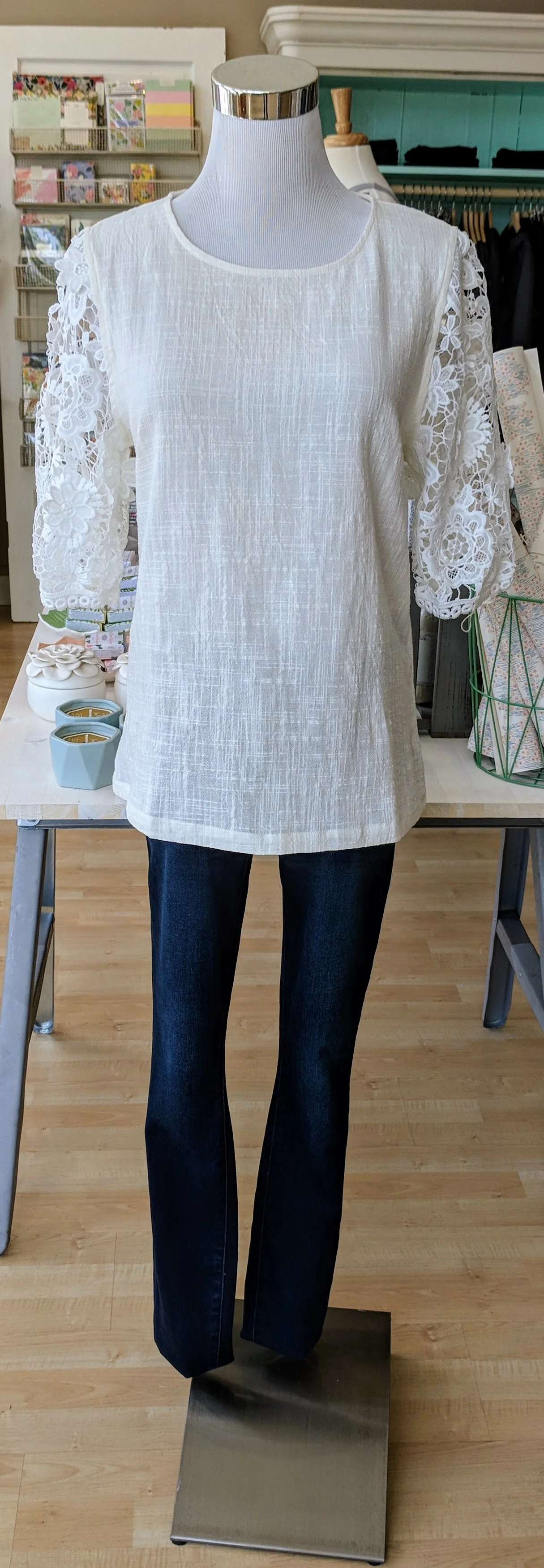 Ivory woven top with floral lace sleeves. 