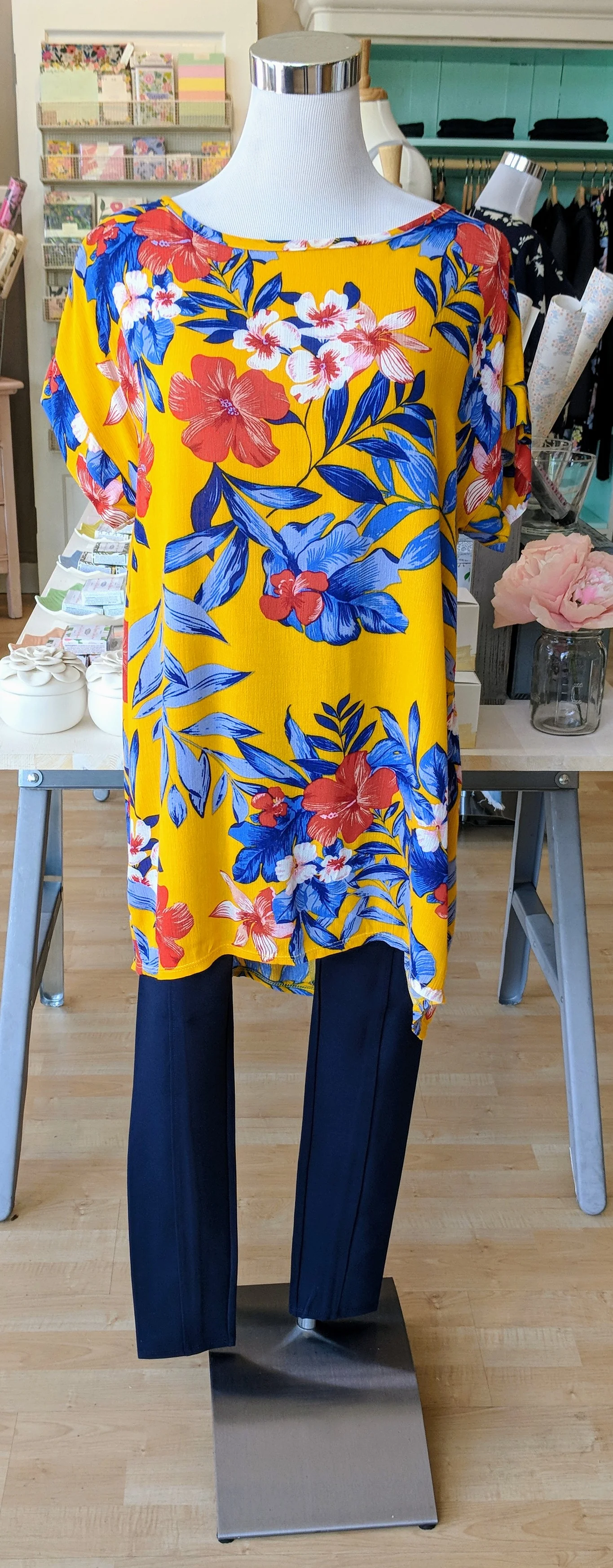Mustard floral high low tunic top with criss-cross detail on back. 