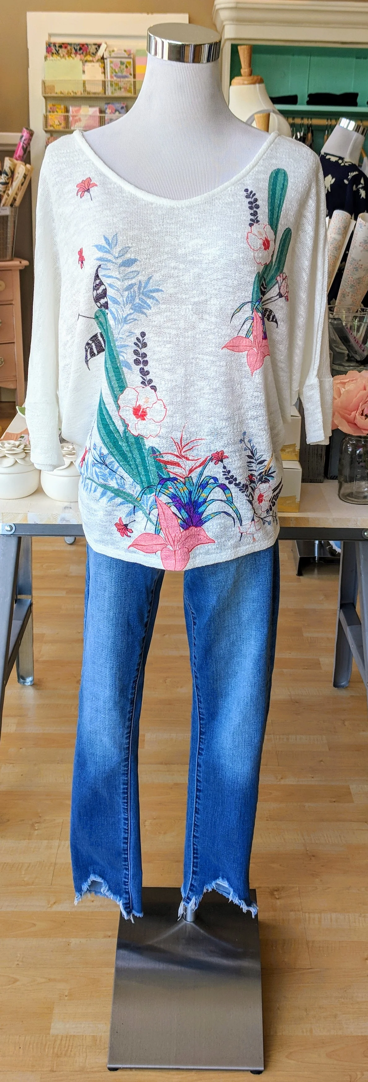 Ivory cactus flower print top with scoop neckline. 