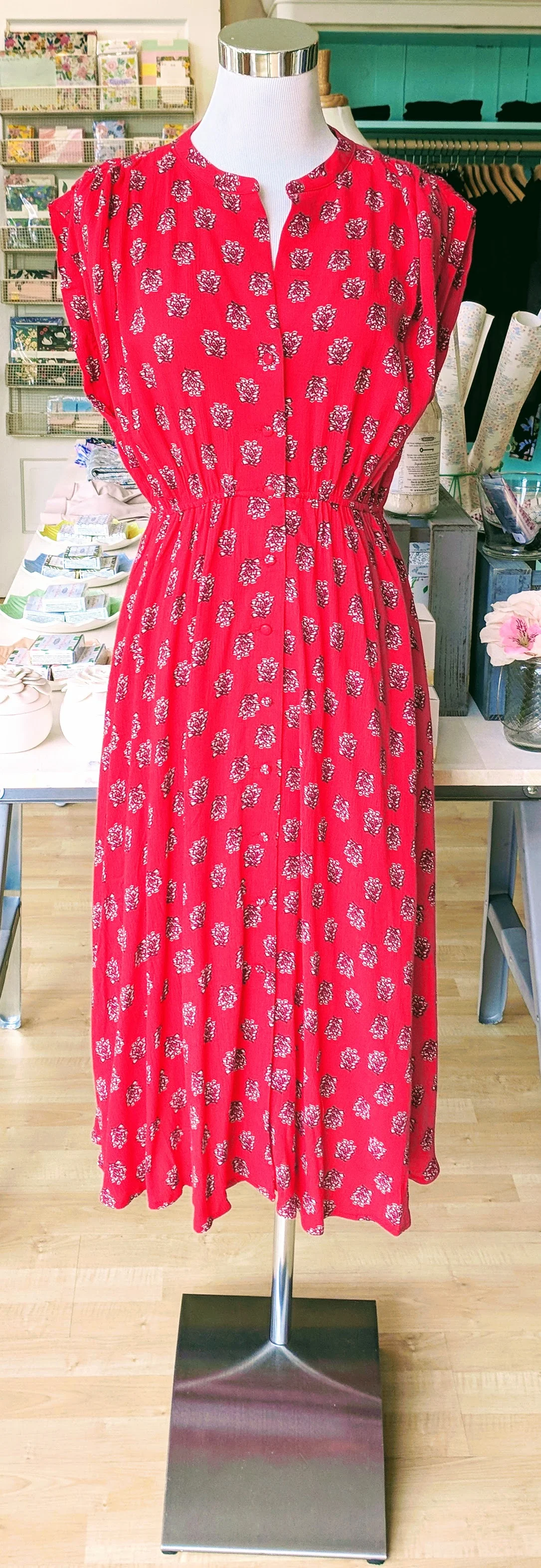 Coral sleeveless midi dress with button detail on front. 
