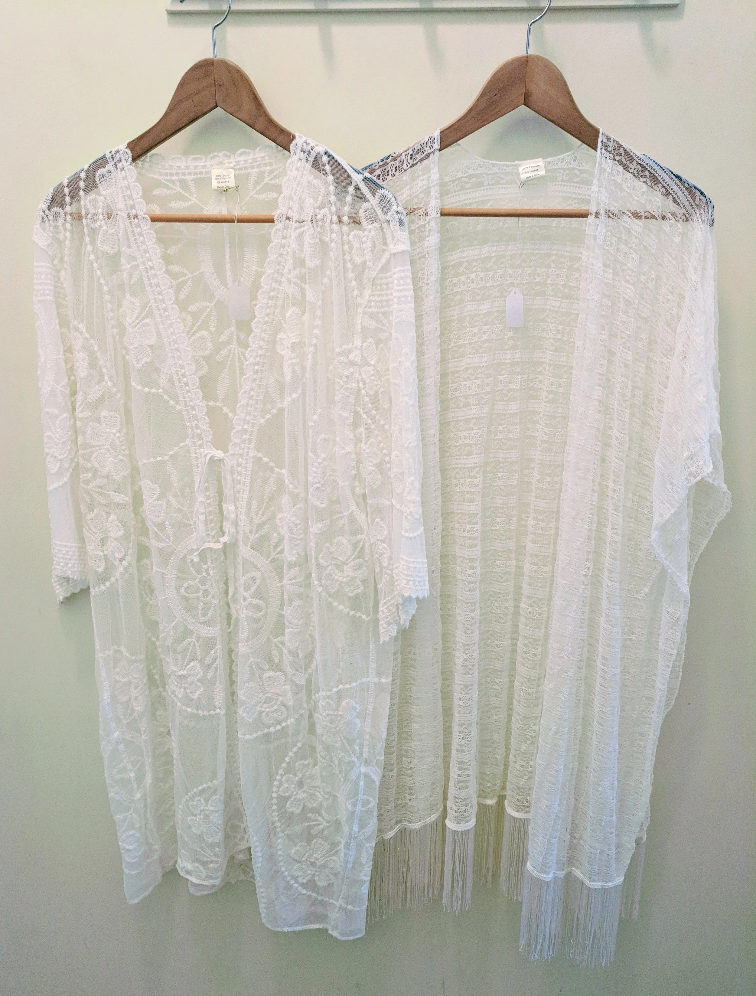 White lace kimono with front tie. White lace kimono with tassel trim. 