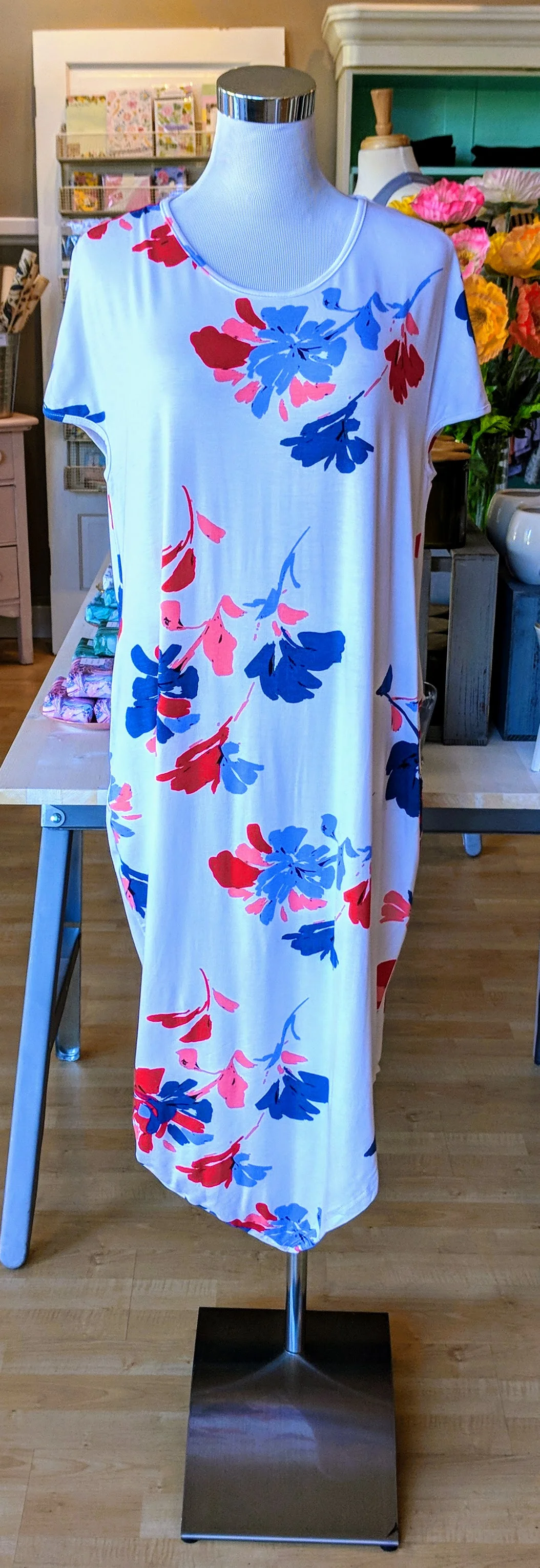 Ivory round neck dress with pockets and uneven hem. 