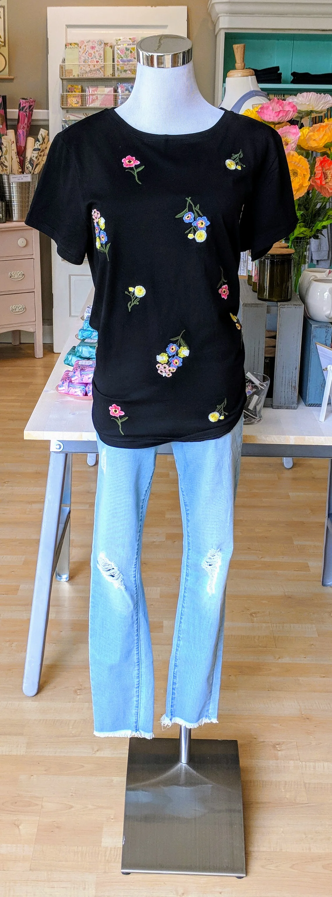 Black floral top with embroidered detail. 