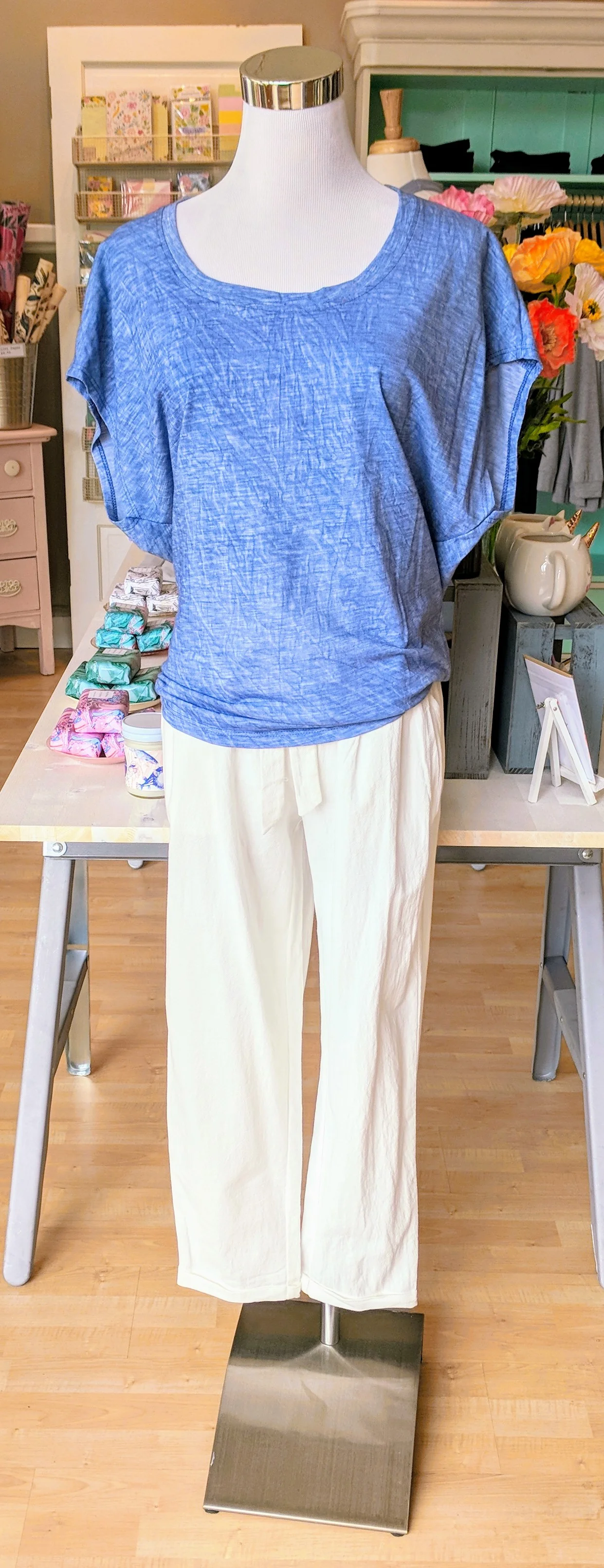 White linen pant with tie waist band. Blue knit top with dolman sleeve. 