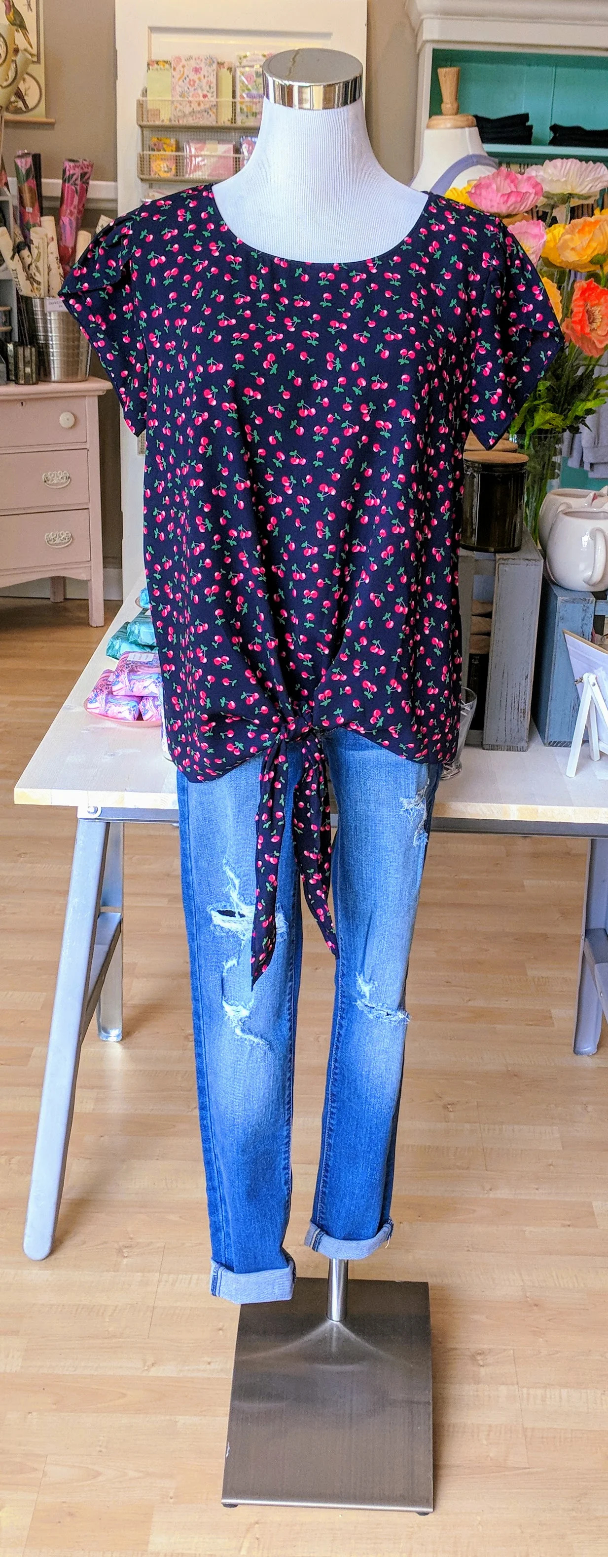 Navy cherry print top with key hole tie detail on front. 