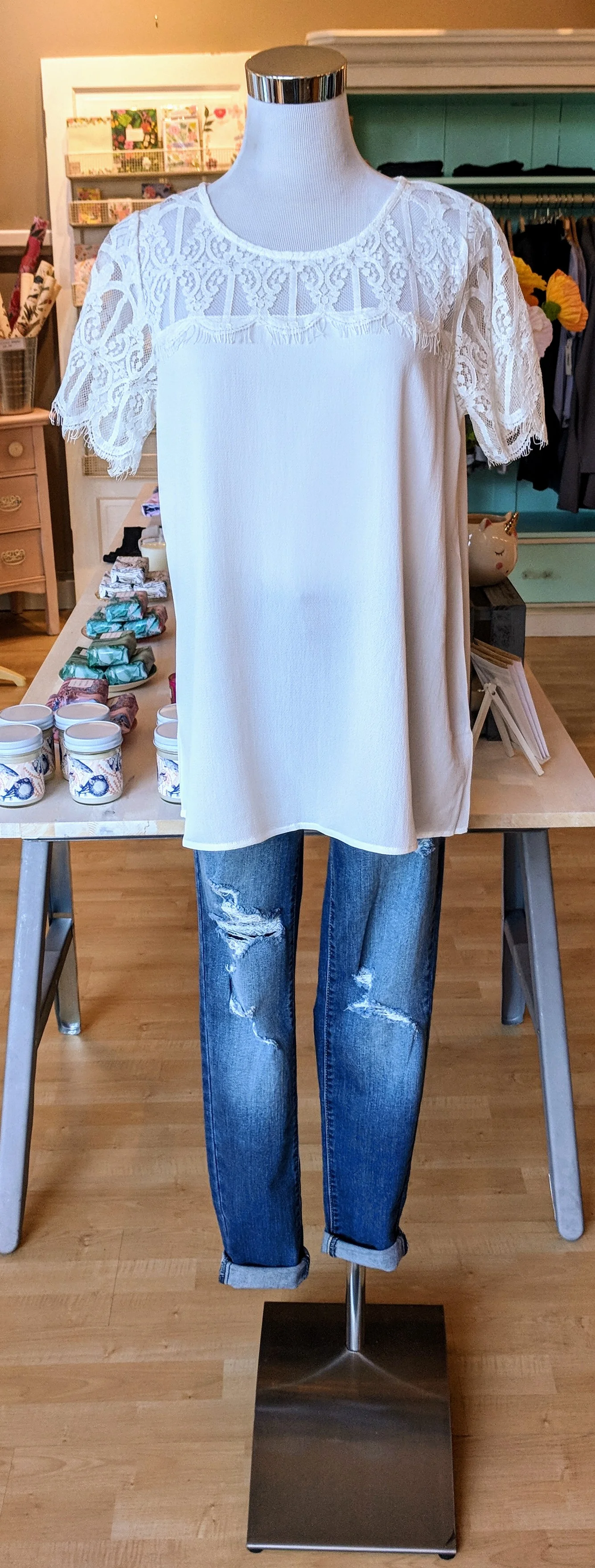 Solid white top with lace sleeves and neckline. 