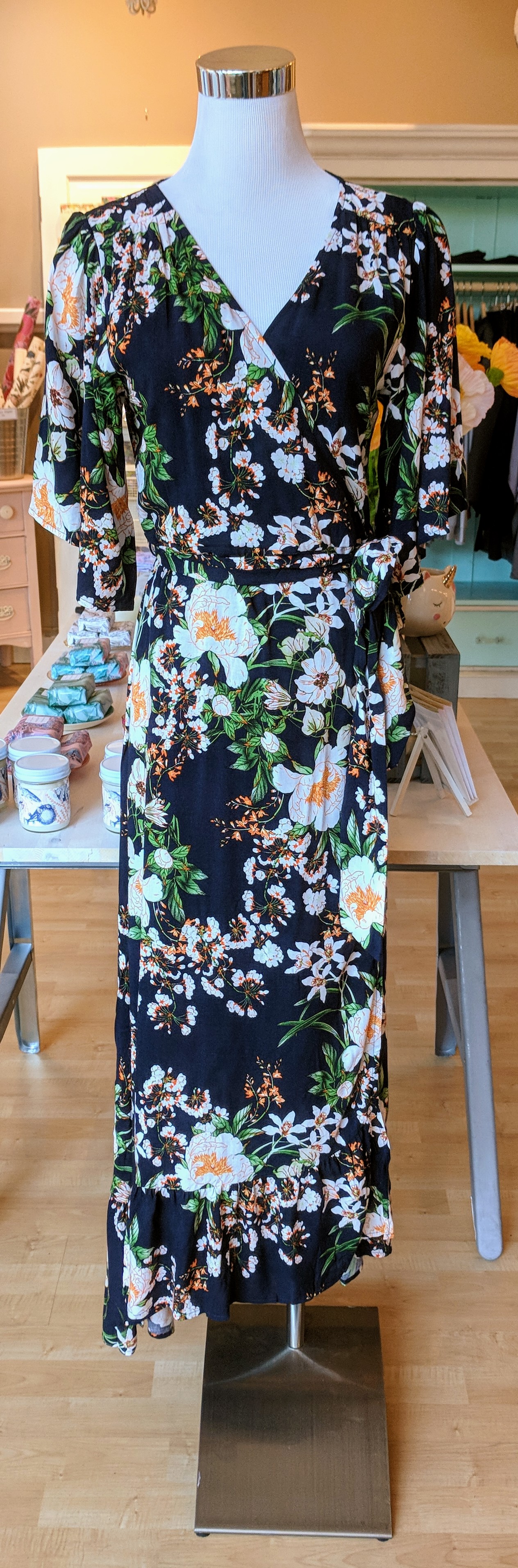 Navy floral wrap dress with hi-low ruffle hem and tie waistband. 