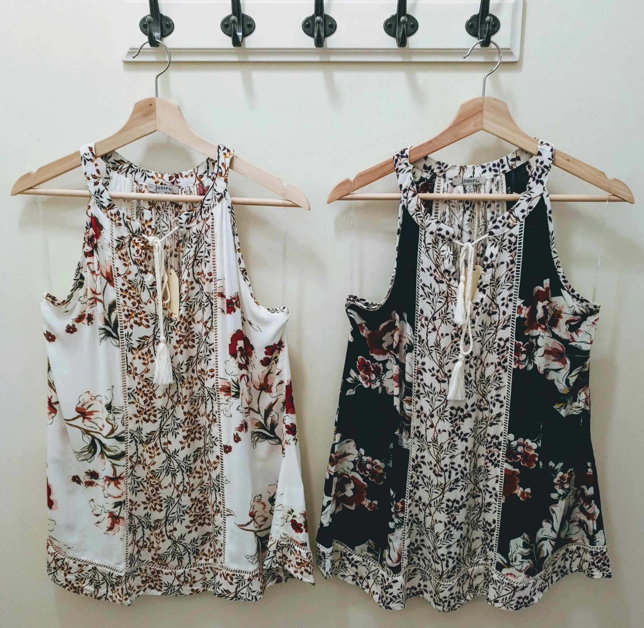 Ivory and Navy multi-print top with tassel tie neckline. 