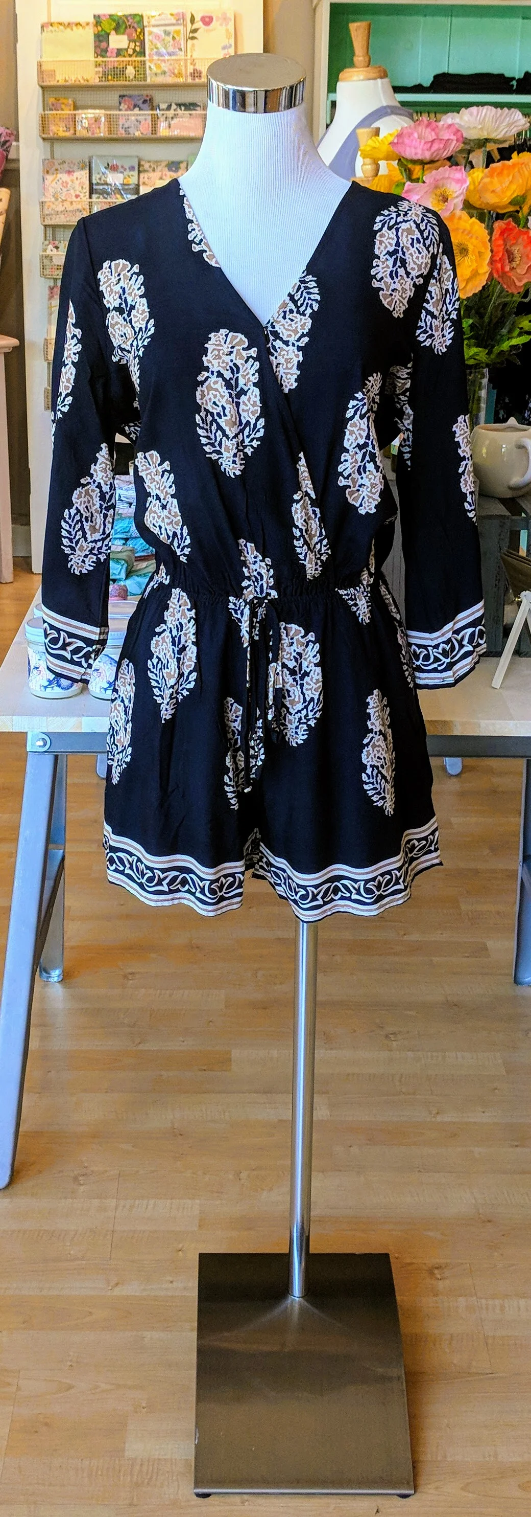Navy and cream romper with button clasp front and tie waist. 
