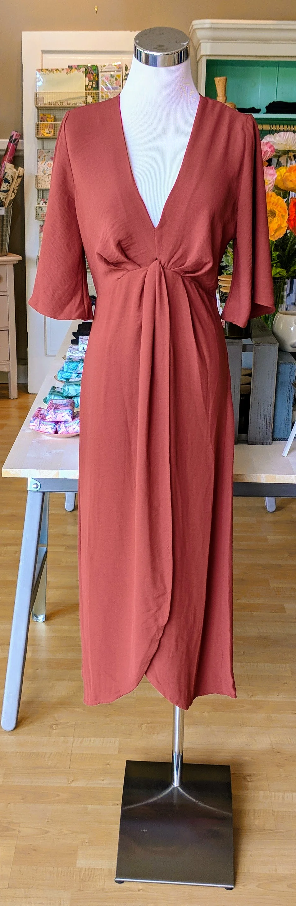 Brick color midi dress with fly away sleeve and knot detail on front. 