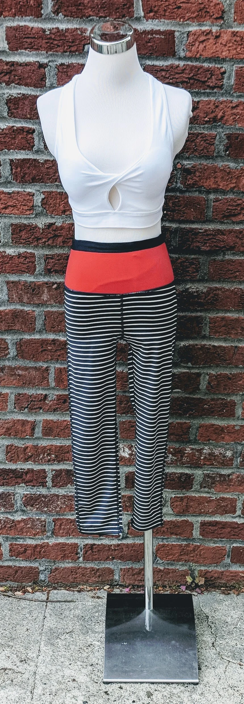 Navy and white stripe capri leggings with red-orange color block waist. 