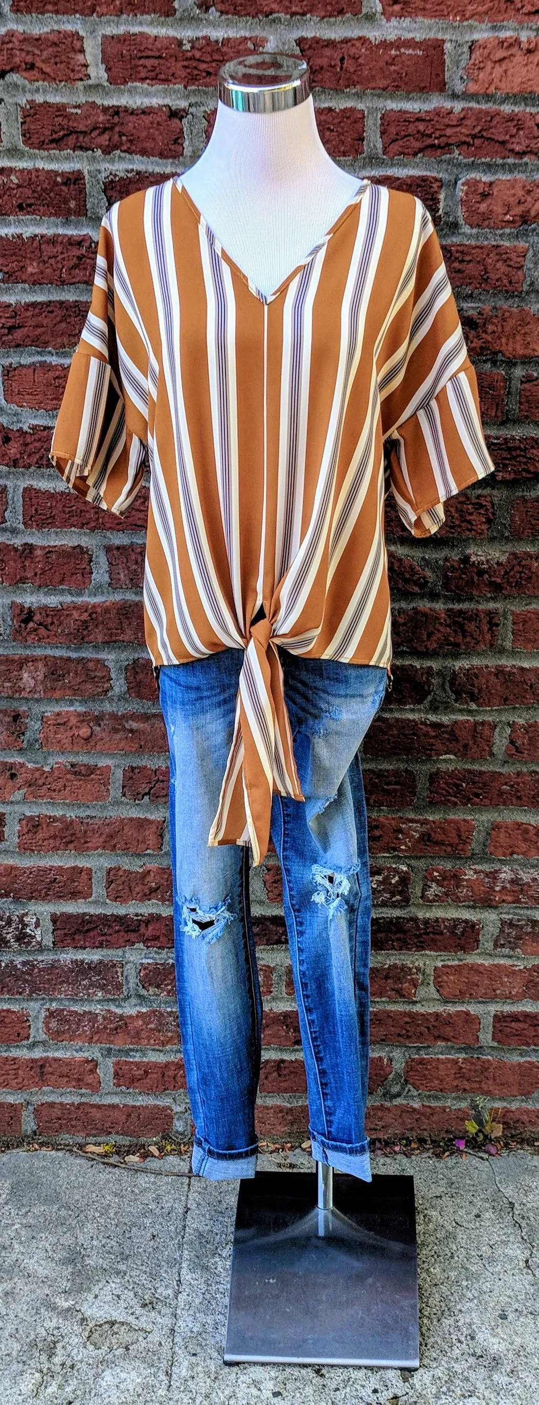 Yellow-Orange stripe top with bell sleeve and tie detail. 