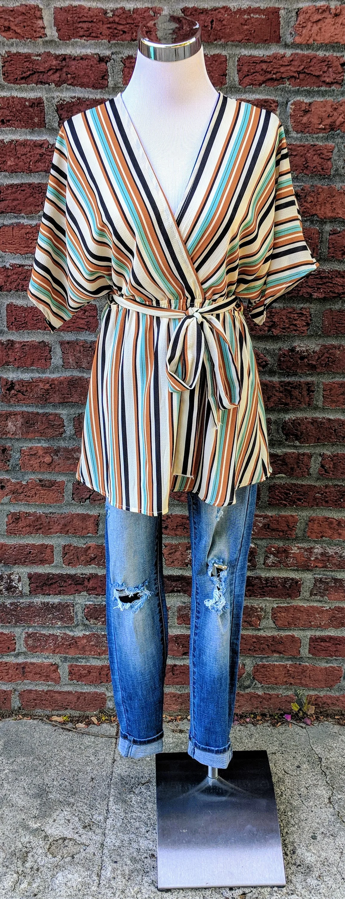 Multi-color stripe dolman top with cinched waist and tie detail. 
