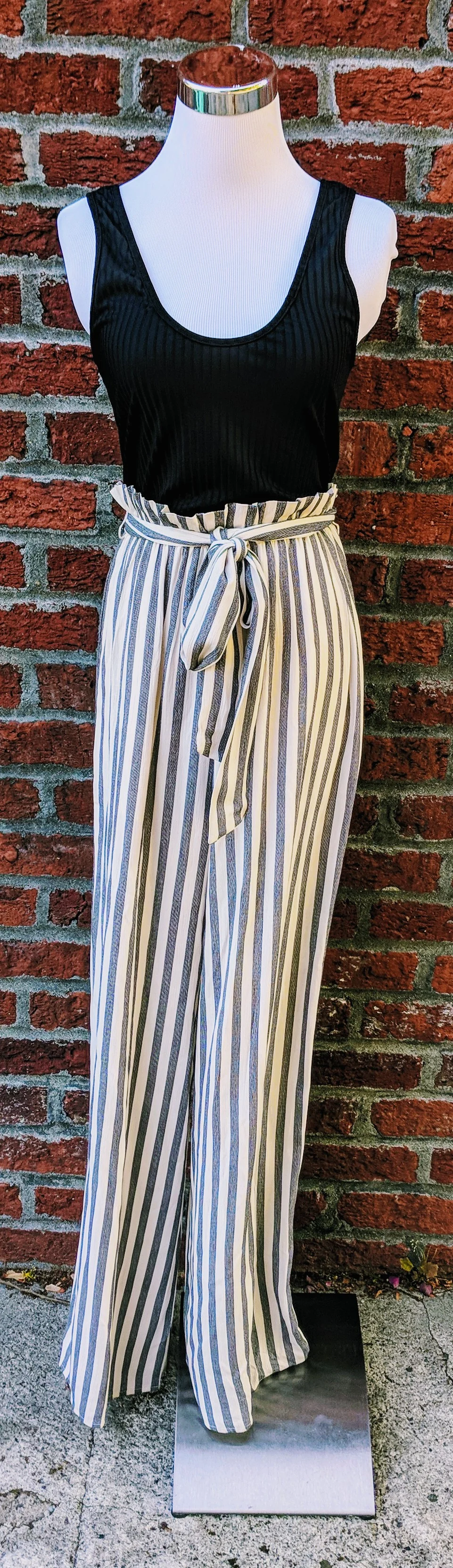 Black and white stripe jumpsuit with belted waist. 